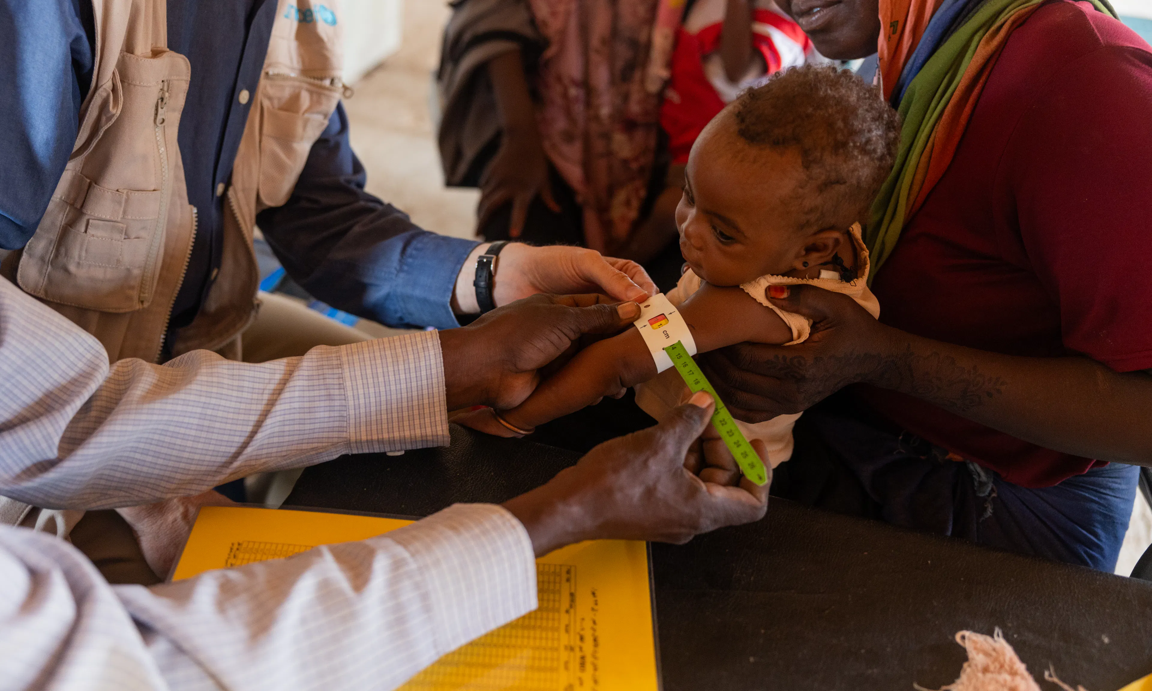 UNICEF Representative Sheldon Yett observes children receiving nutrition services and care at Mayo Mandela clinic in Jebel Awlia, Sudan.
