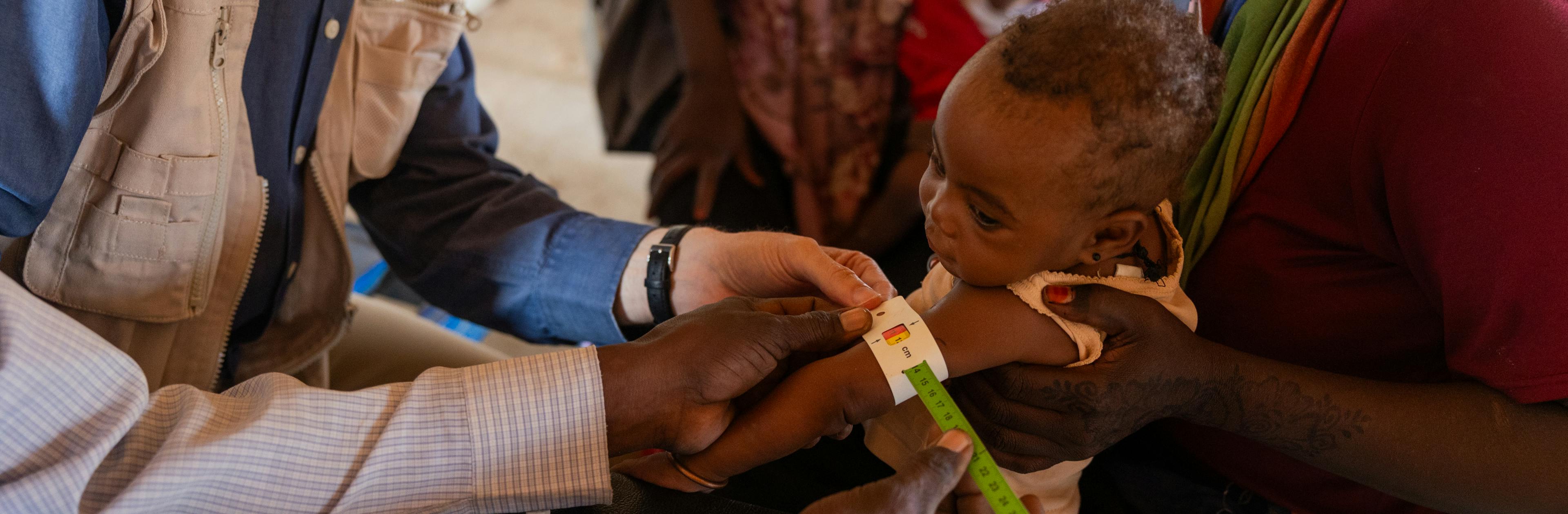 UNICEF Representative Sheldon Yett observes children receiving nutrition services and care at Mayo Mandela clinic in Jebel Awlia, Sudan.