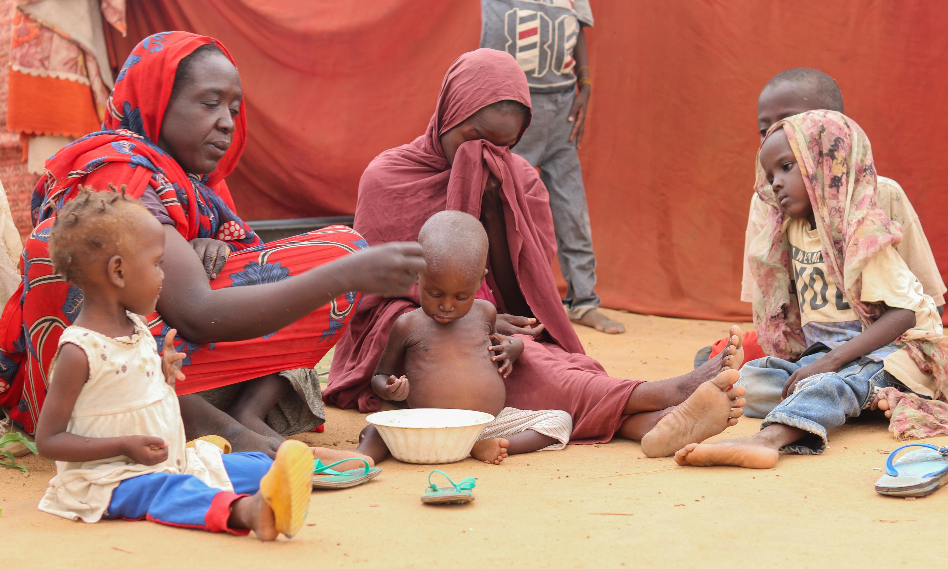 On 14 August, mothers with their children in a gathering site in Al Fasher, North Darfur.