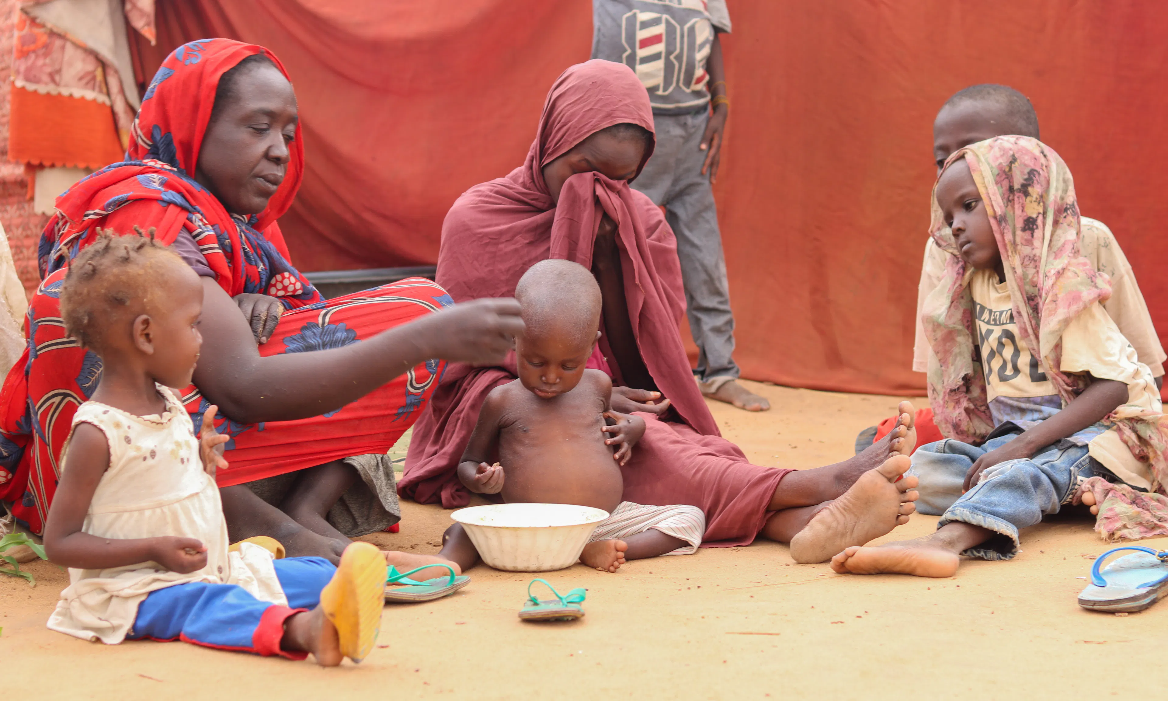 On 14 August, mothers with their children in a gathering site in Al Fasher, North Darfur.