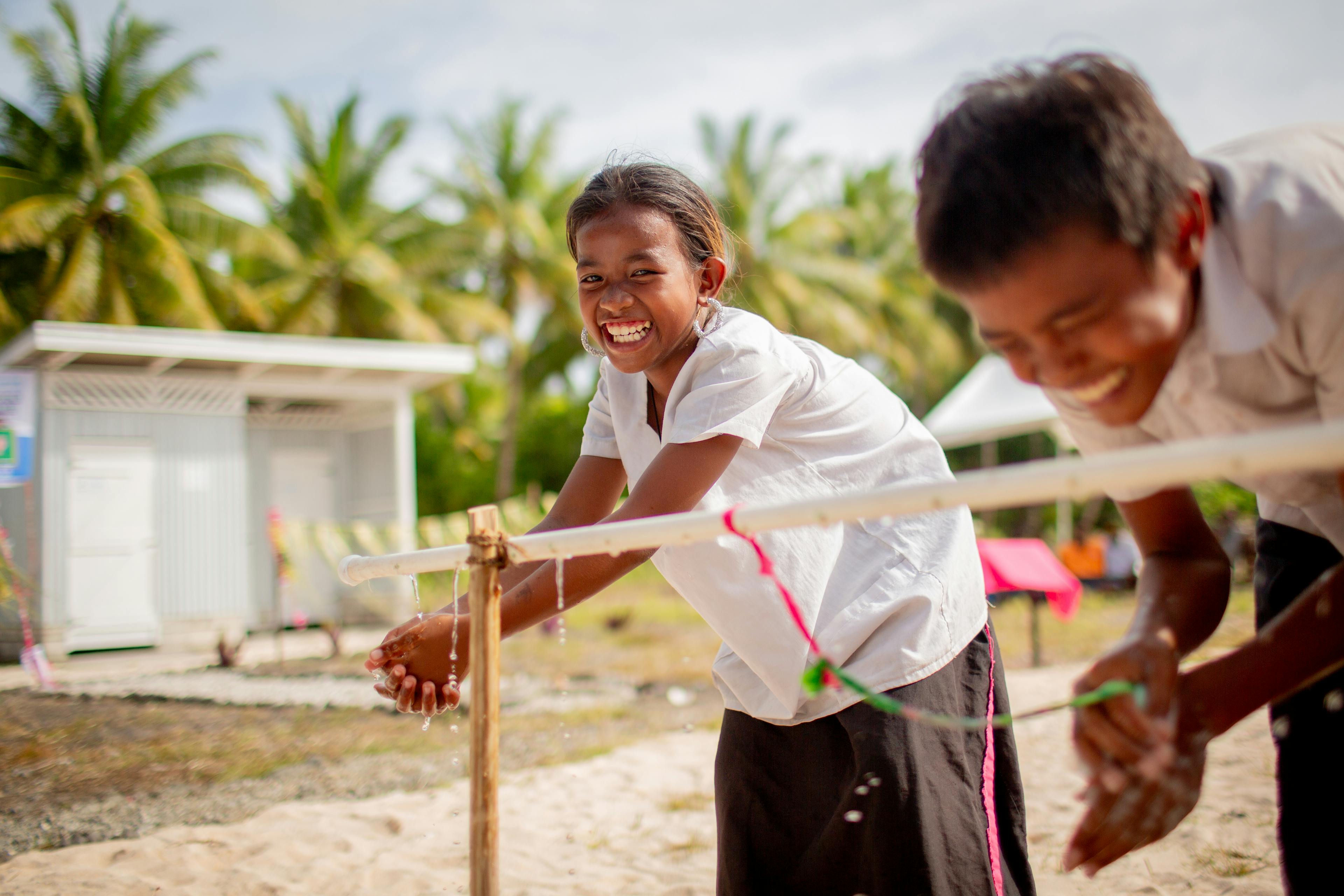 A child washes their hands
