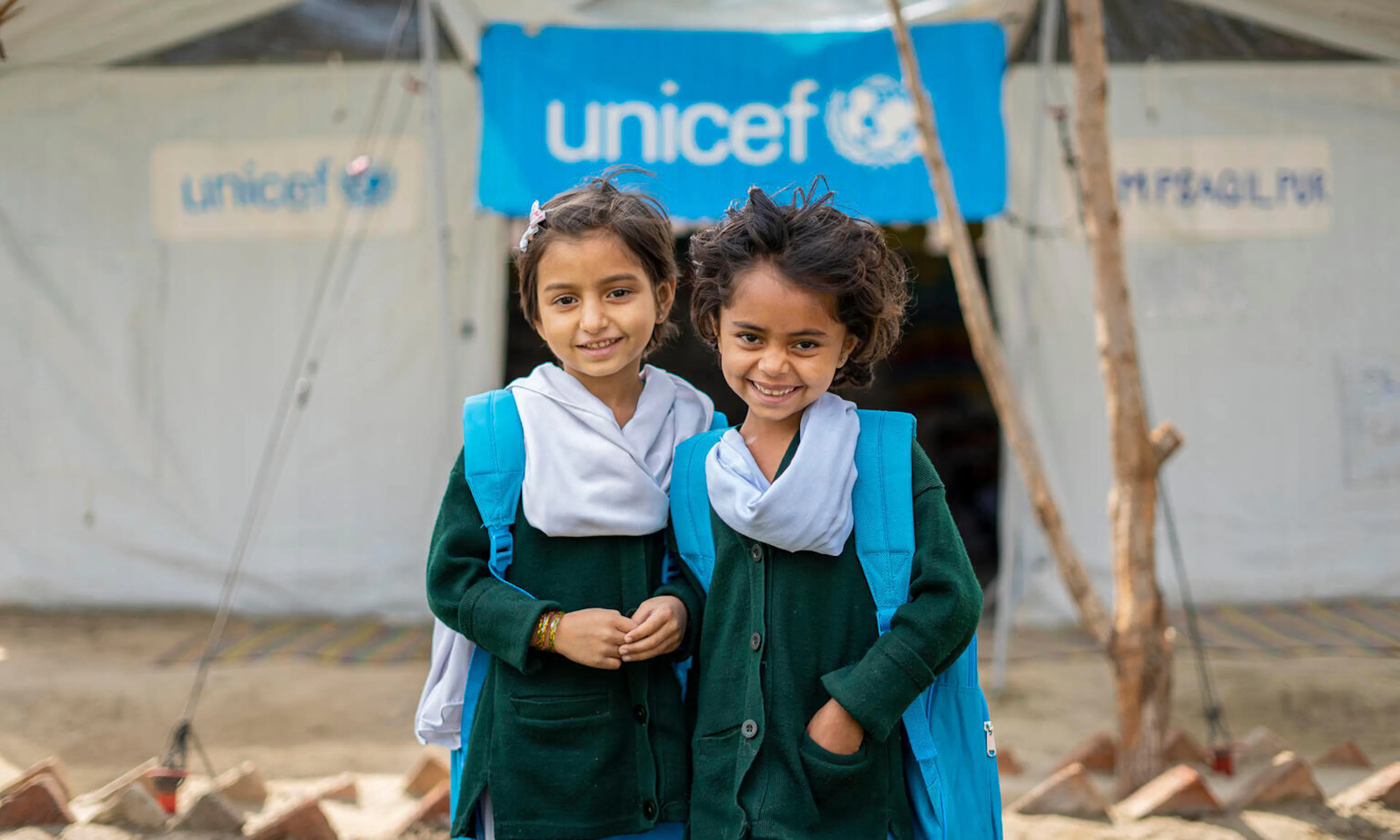 Two girls receive UNICEF backpacks