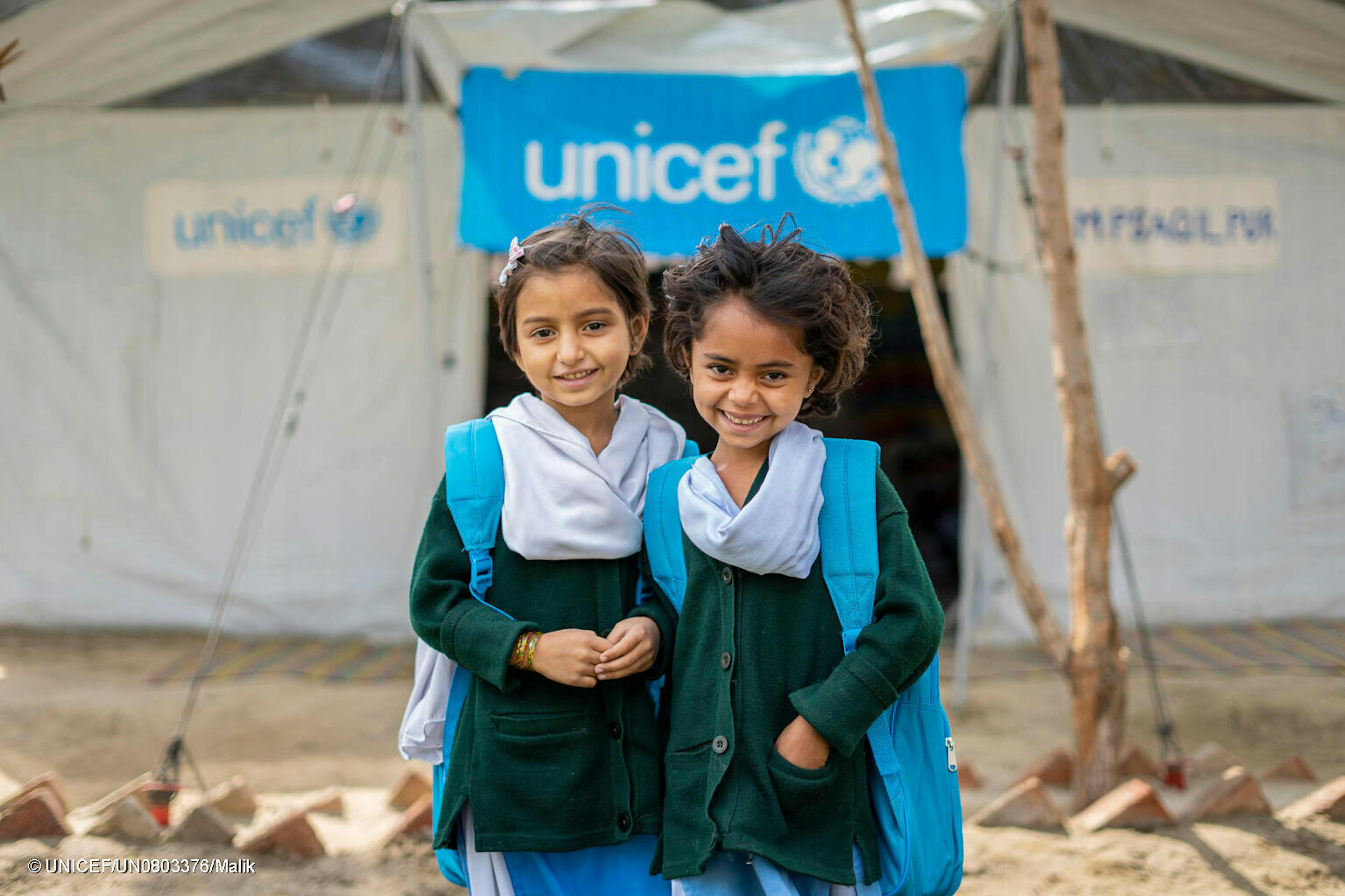 Two girls receive UNICEF backpacks