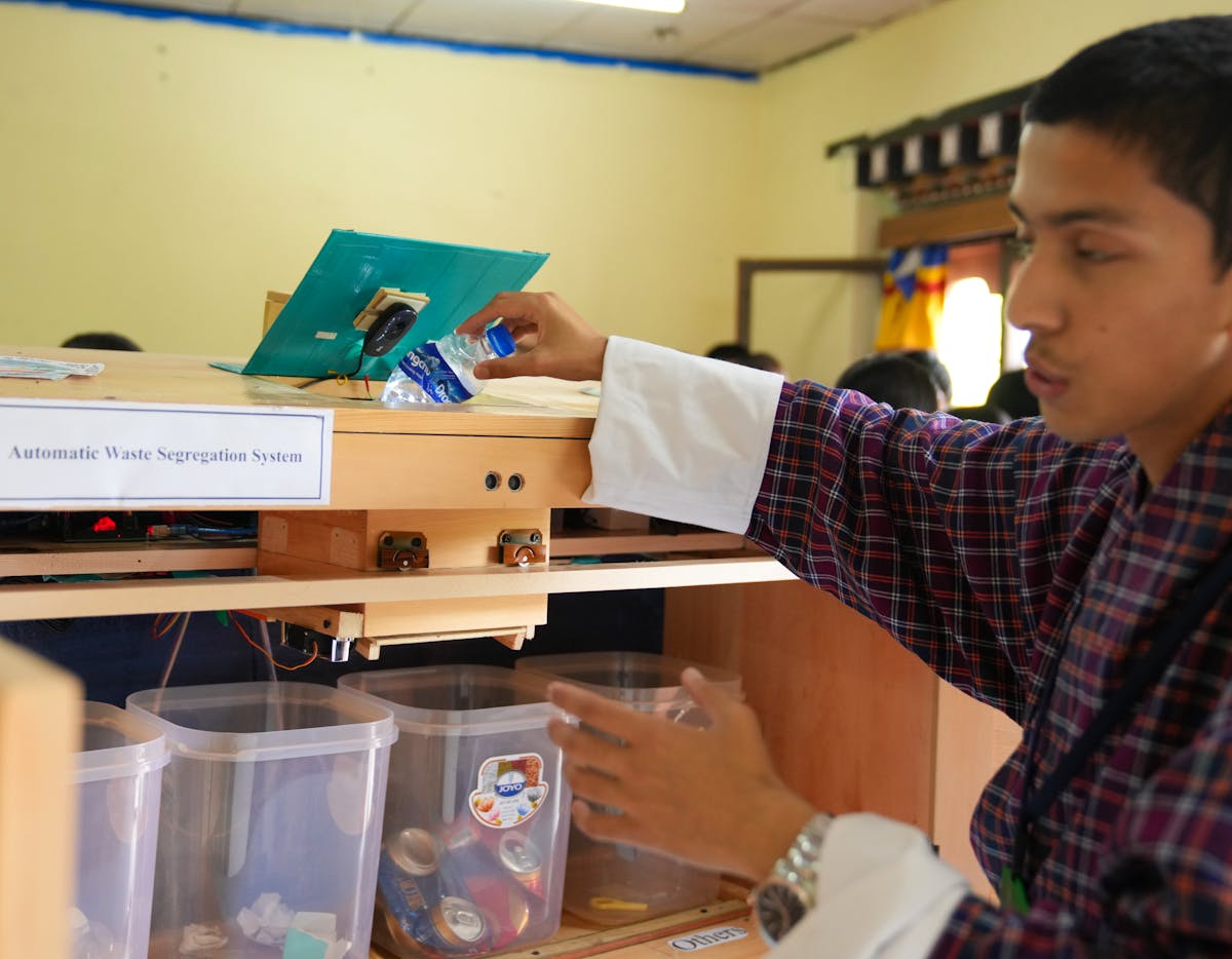 A Bhutan student showing their recycling innovation