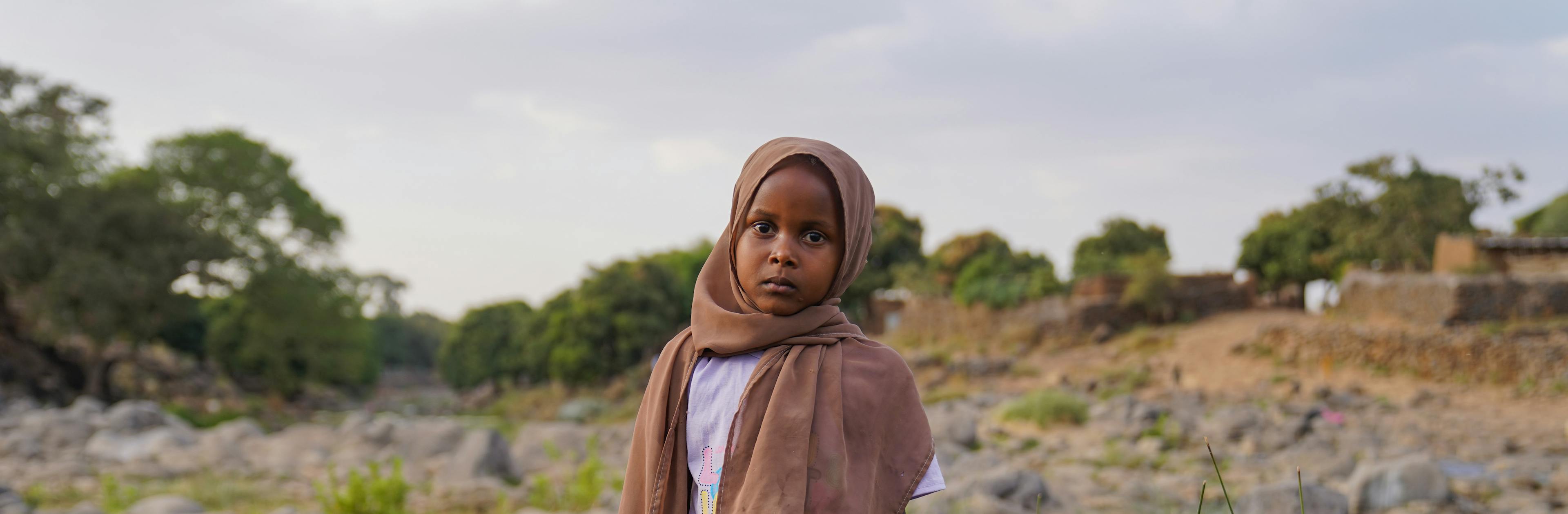 A child in a field in Sudan