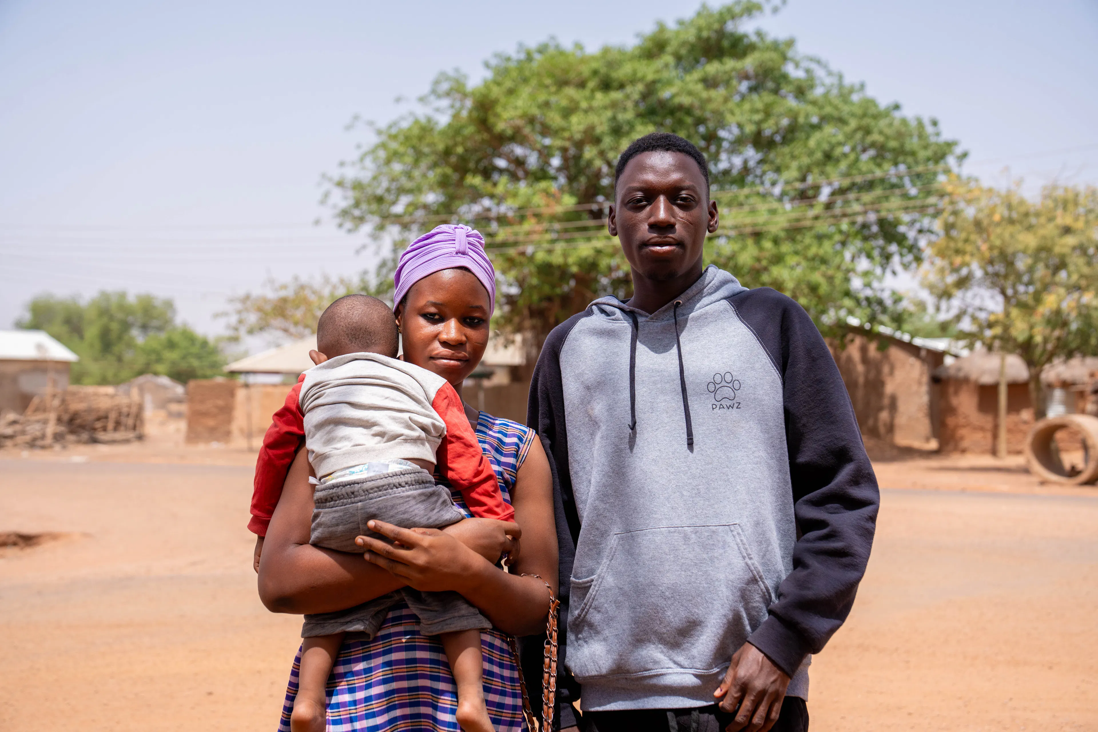 Mother-holds-baby-with-father-standing-next-to-her