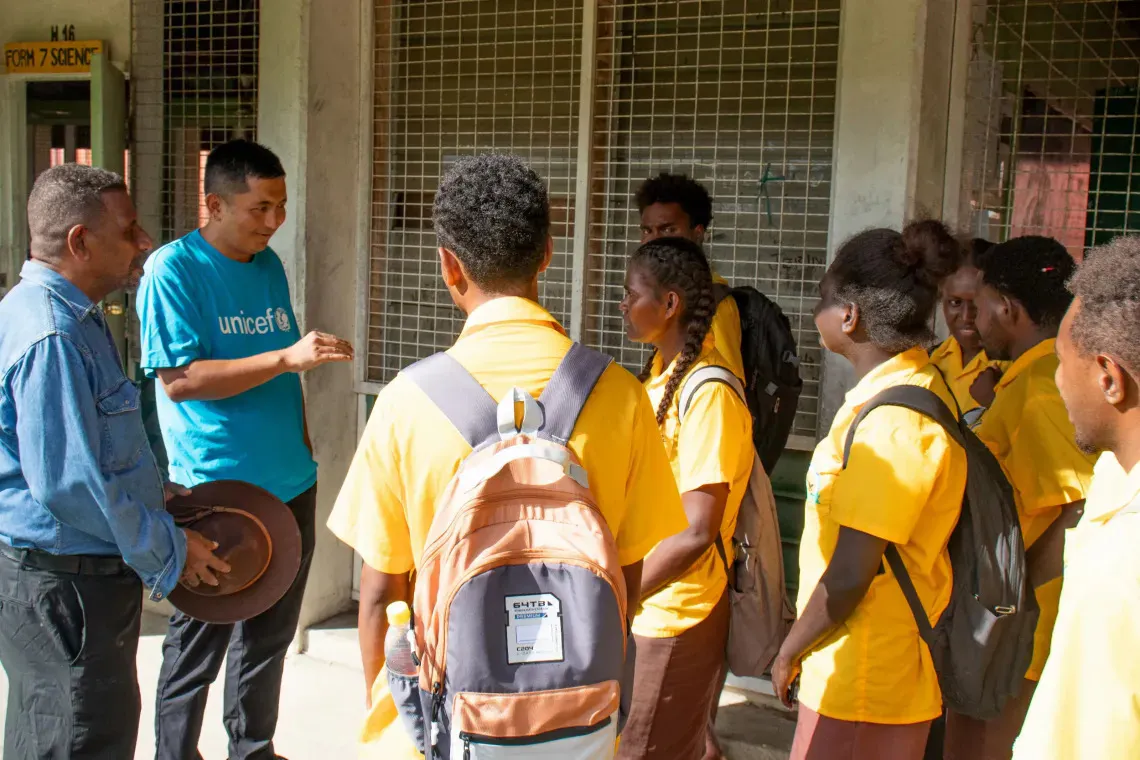 UNICEF Pacific Chief of WASH Kencho Namgyal and Chairman of Board Joe Billy Oge chatting with students of Honiara Senior High School during a visit to the school