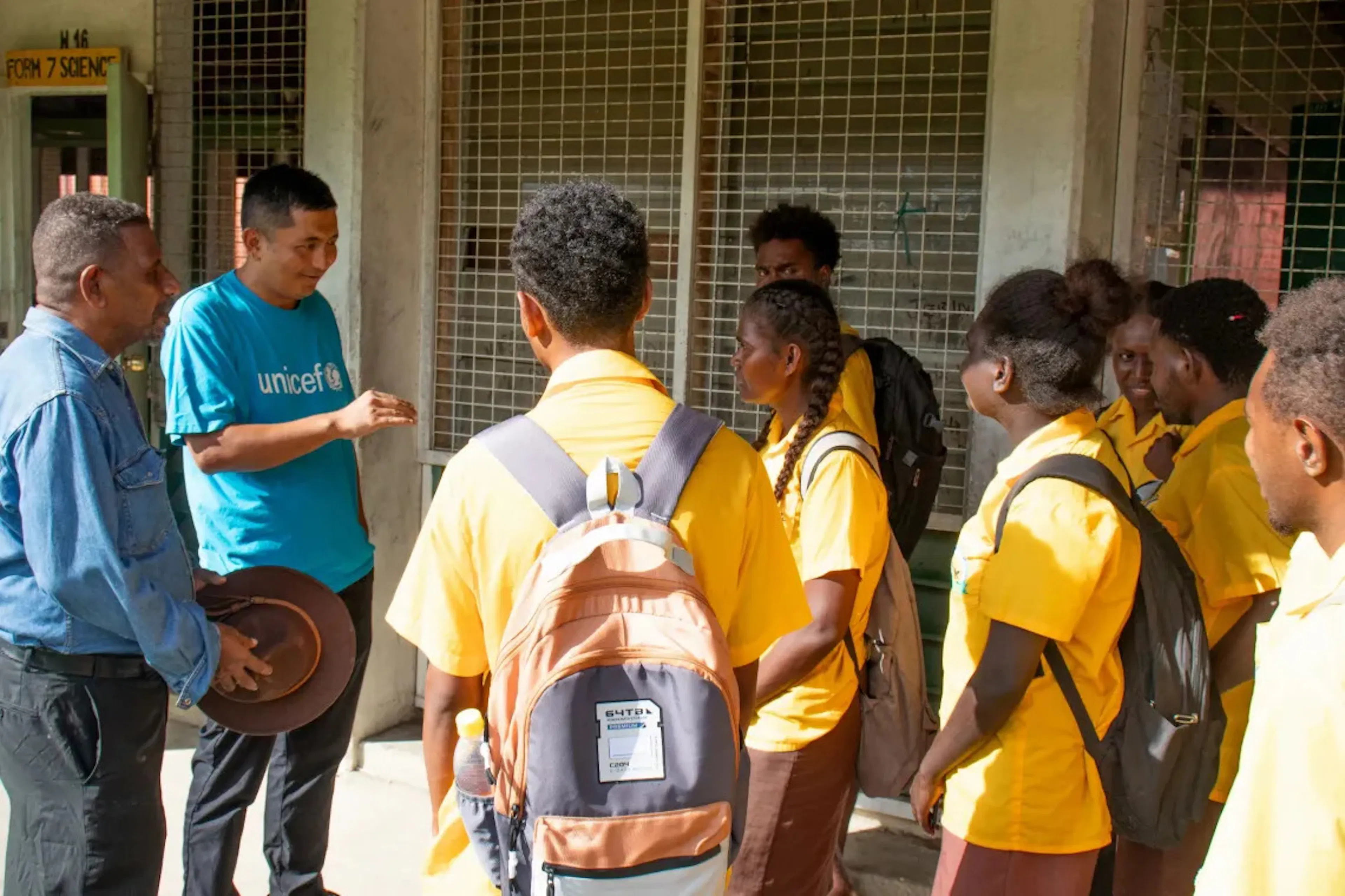 UNICEF Pacific Chief of WASH Kencho Namgyal and Chairman of Board Joe Billy Oge chatting with students of Honiara Senior High School during a visit to the school