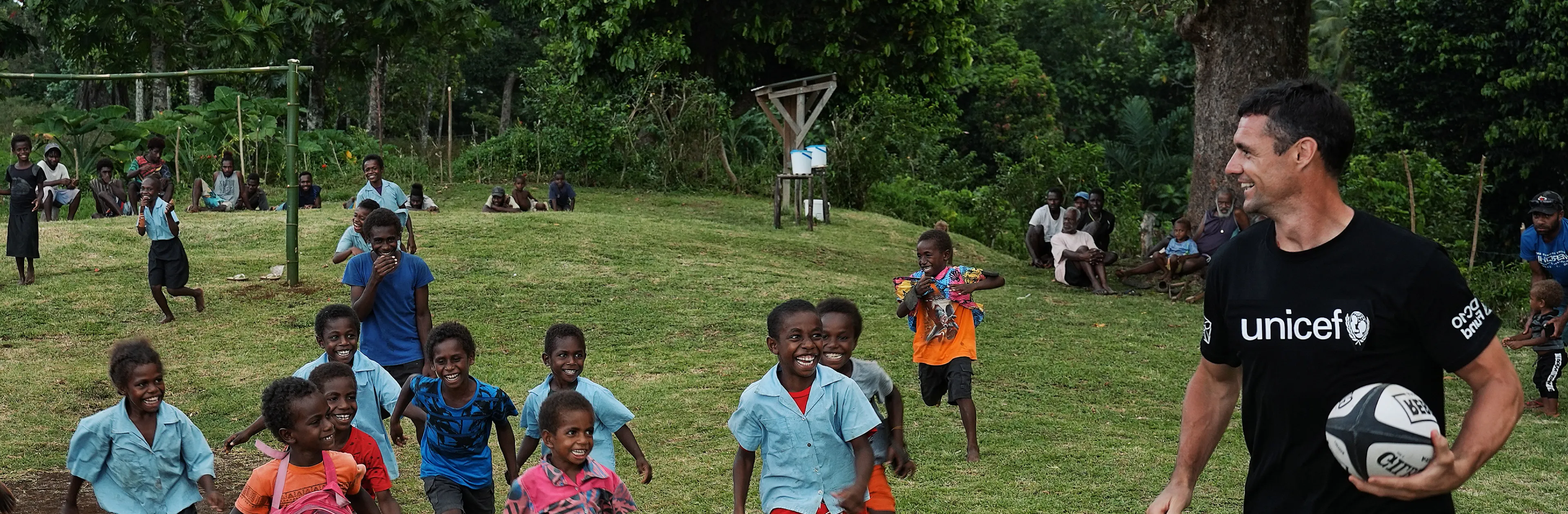Dan Carter plays rugby with school kids in the Pacific.
