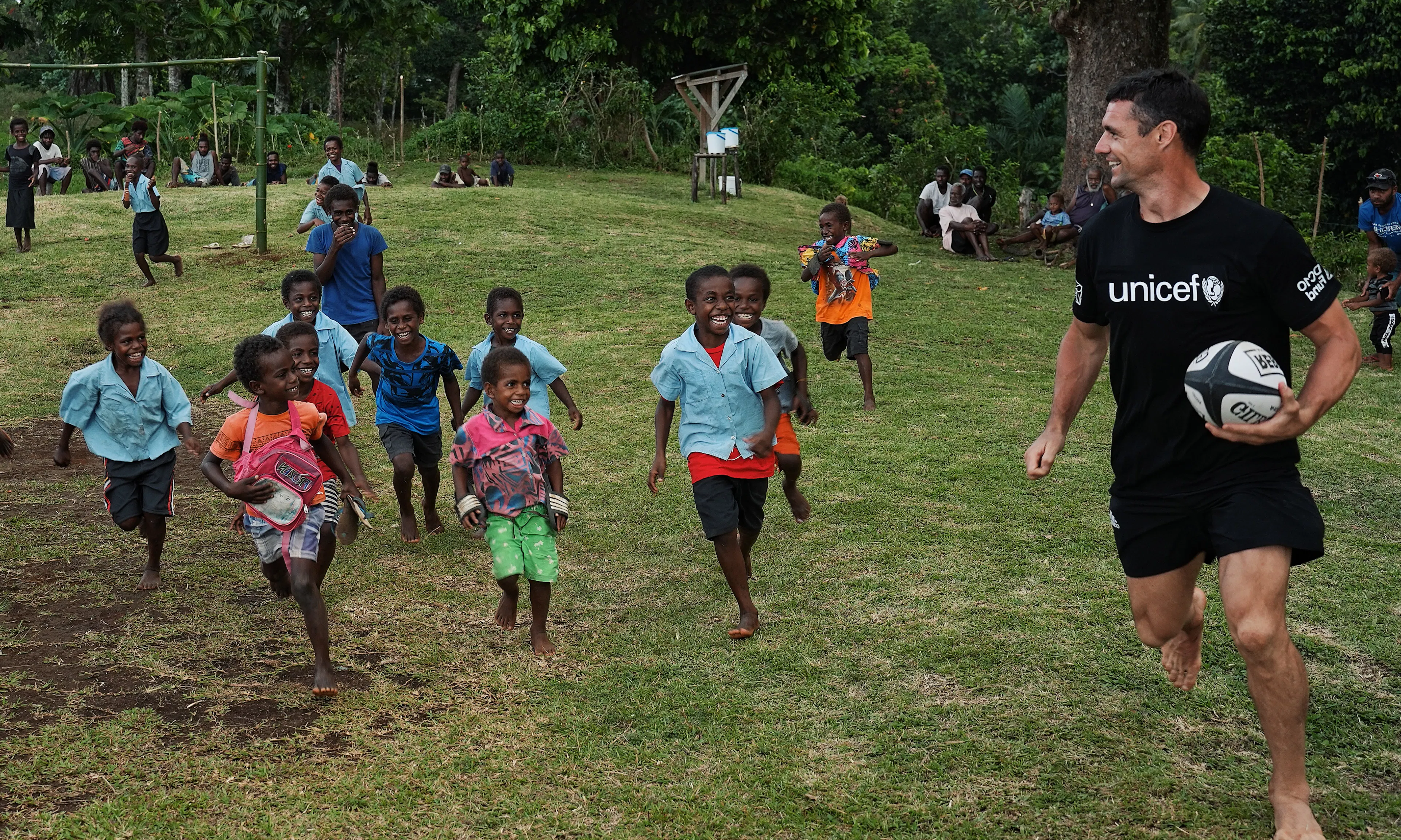 Dan Carter plays rugby with school kids in the Pacific.