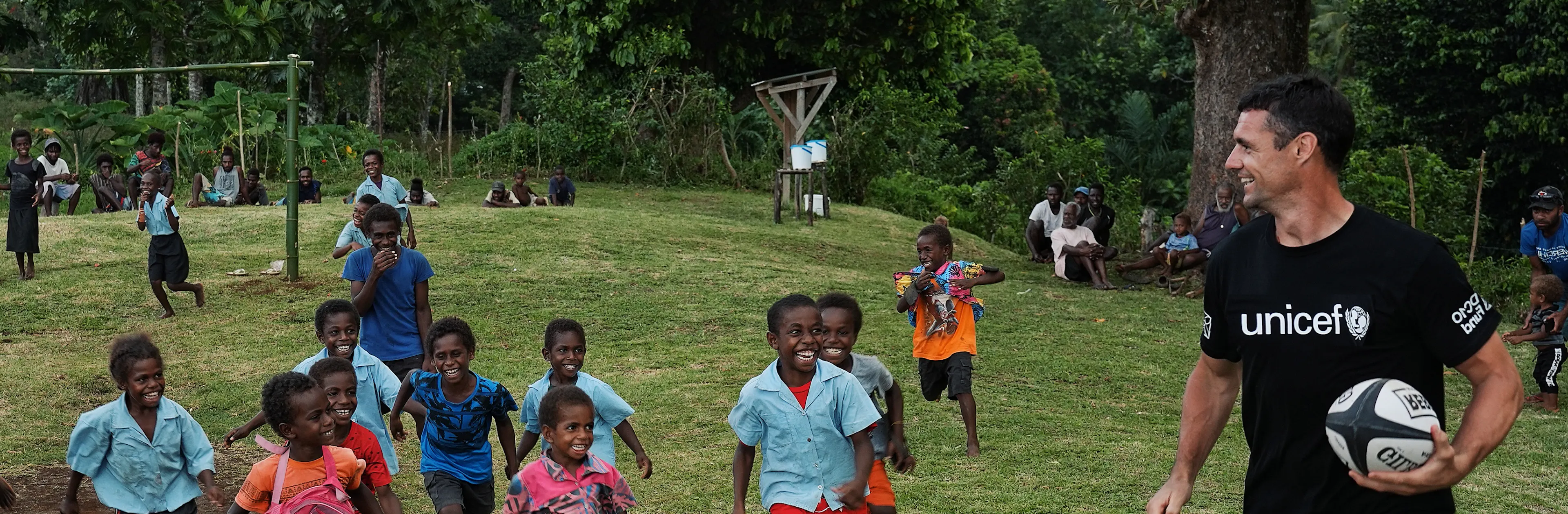 Dan Carter plays rugby with school kids in the Pacific.