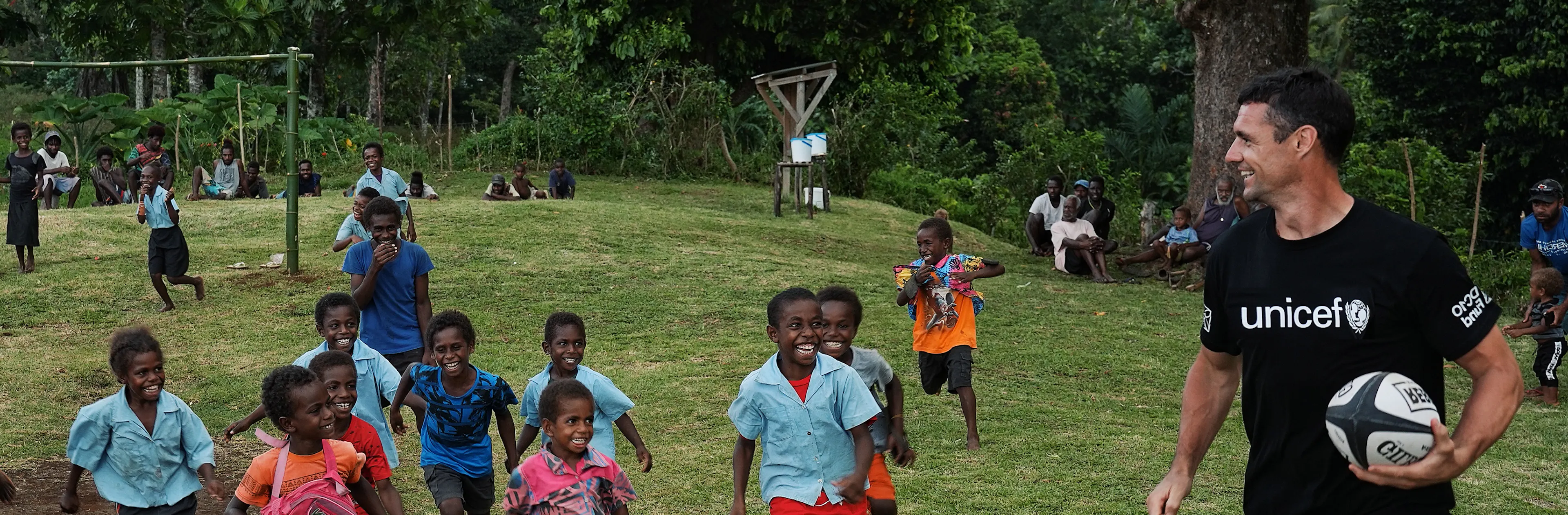 Dan Carter plays rugby with school kids in the Pacific.