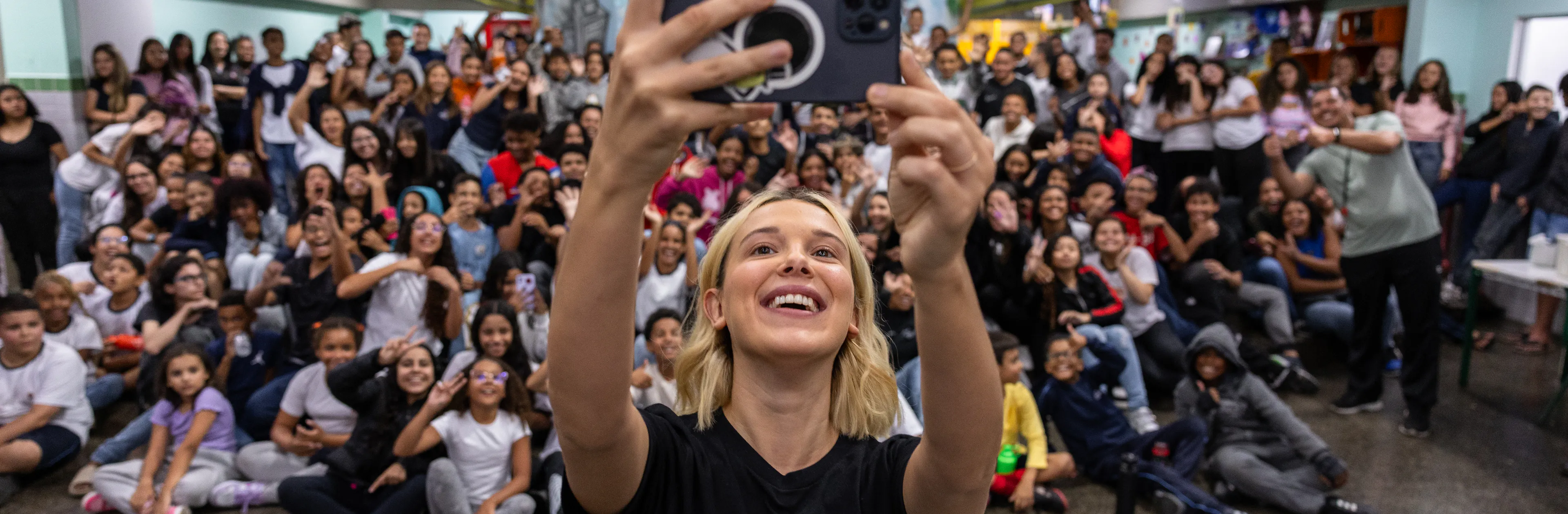 On 17 March 2025 in São Paulo, Brazil, UNICEF Goodwill Ambassador Millie Bobby Brown takes a selfie with the students at Olinda Menezes Serra Vidal Elementary School, which is located in a vulnerable neighbourhood where UNICEF operates.