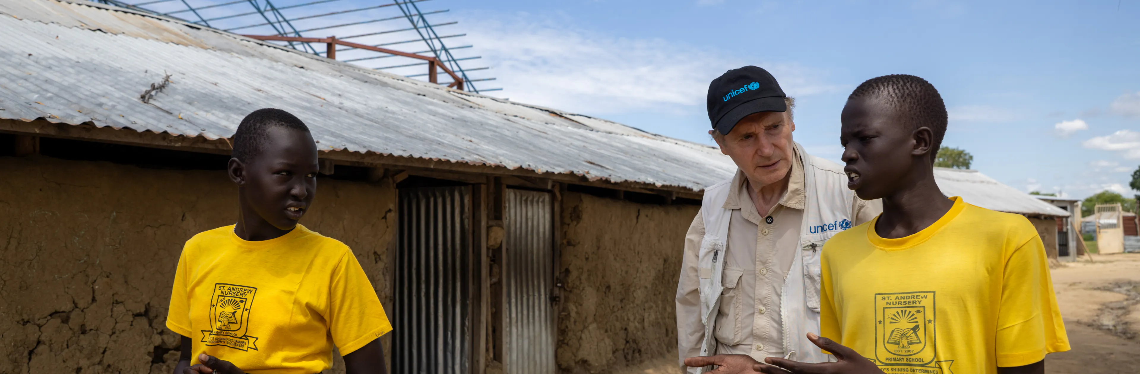 On 22 October 2025, UNICEF Goodwill Ambassador Liam Neeson speaks with young reporters at St. Andrew School in Bor, South Sudan.