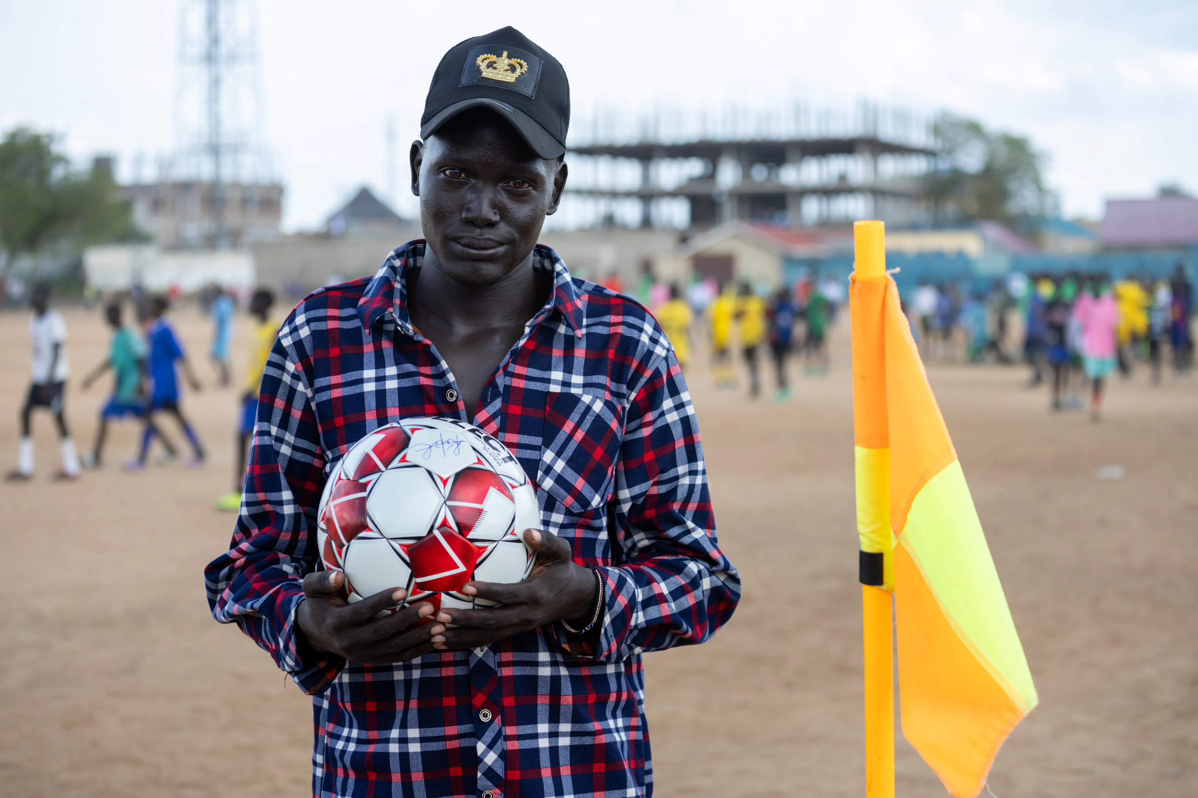 On 19 October 2025 in South Sudan, Alaak Kuku, founder of the Young Dreams Foundation (YDF), poses for a portrait at a YDF Academy sports tournament in Juba during a visit by UNICEF Goodwill Ambassador Liam Neeson.