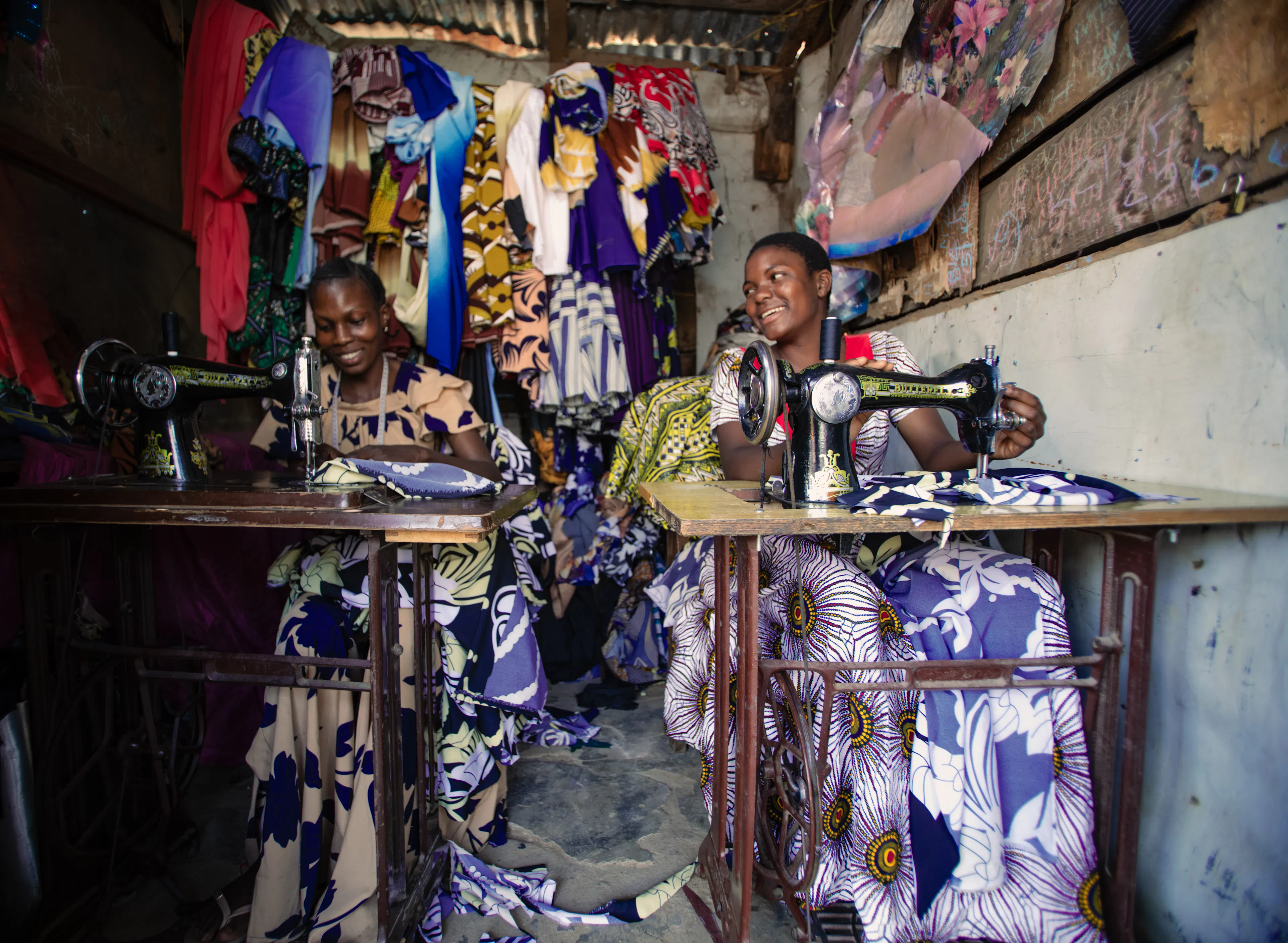 On 13 August 2025,  Antini Mahepa (right), 17, works as a sewing apprentice, alongside her mentor Ester Matata Ngoma, 25, in a local market located in the Uvinza District of the Kigoma Region in Tanzania. The small stall, lined with colourful fabrics and garments, is a place for learning and growth.