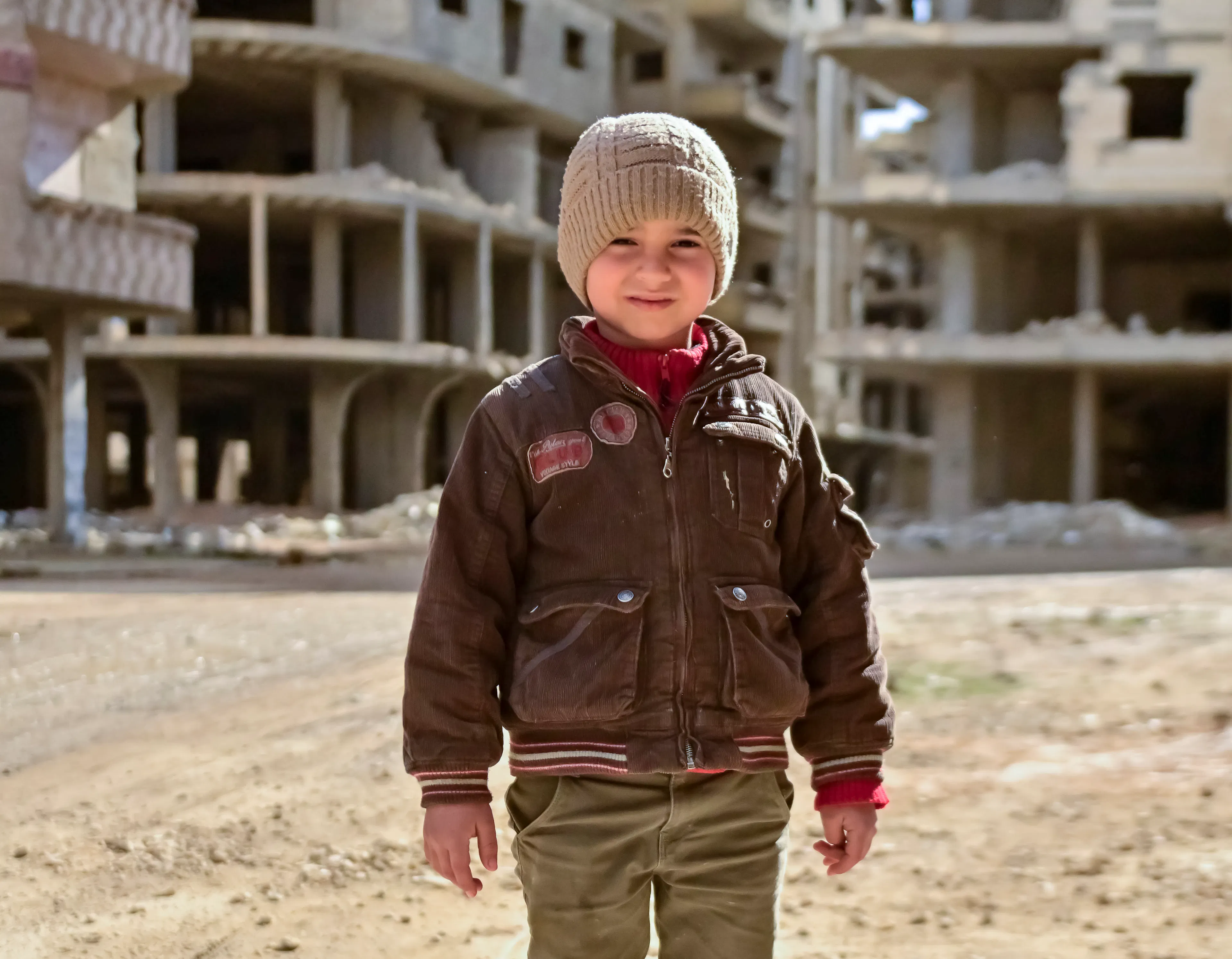 Nasser, 5, stands near his home in Tadamon neighbourhood, where UNICEF-supported rehabilitation of the sewage network is taking place.