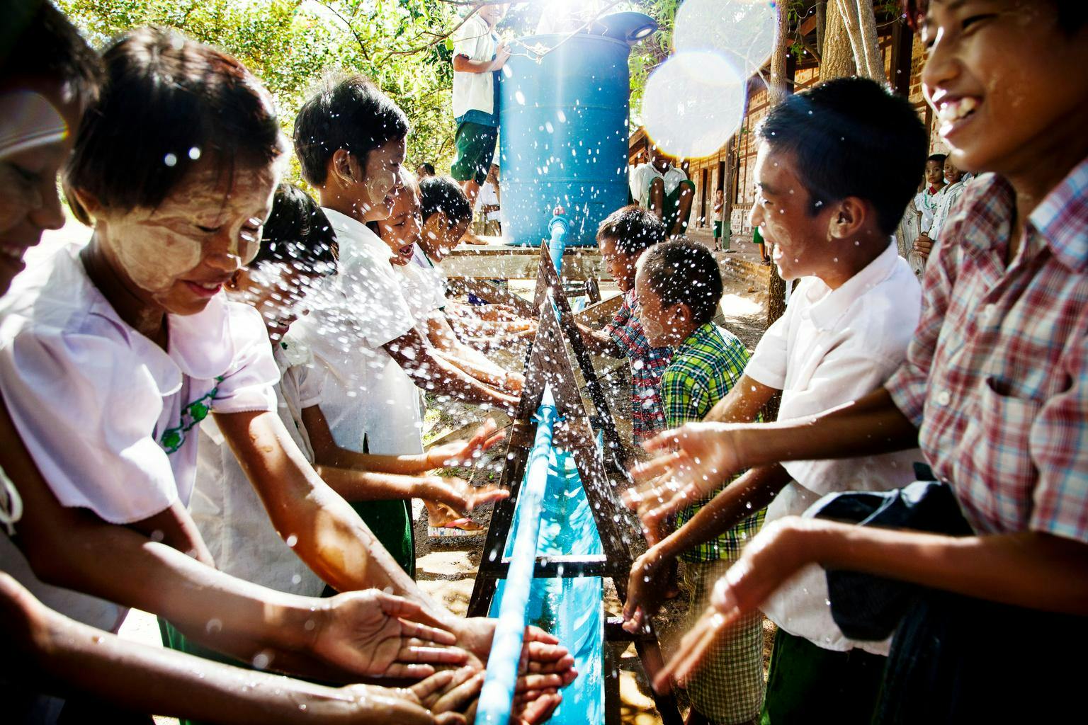 kids using UNICEF easy to construct group hand-washing station 