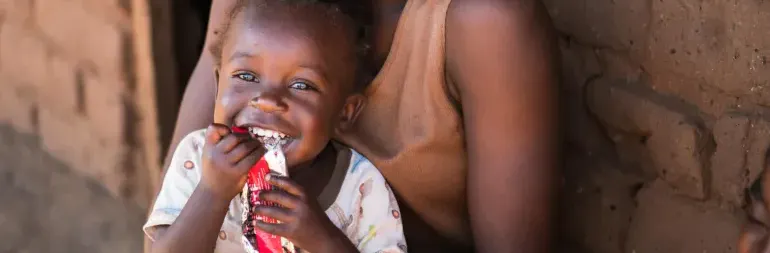 A child eats a RUTF sachet