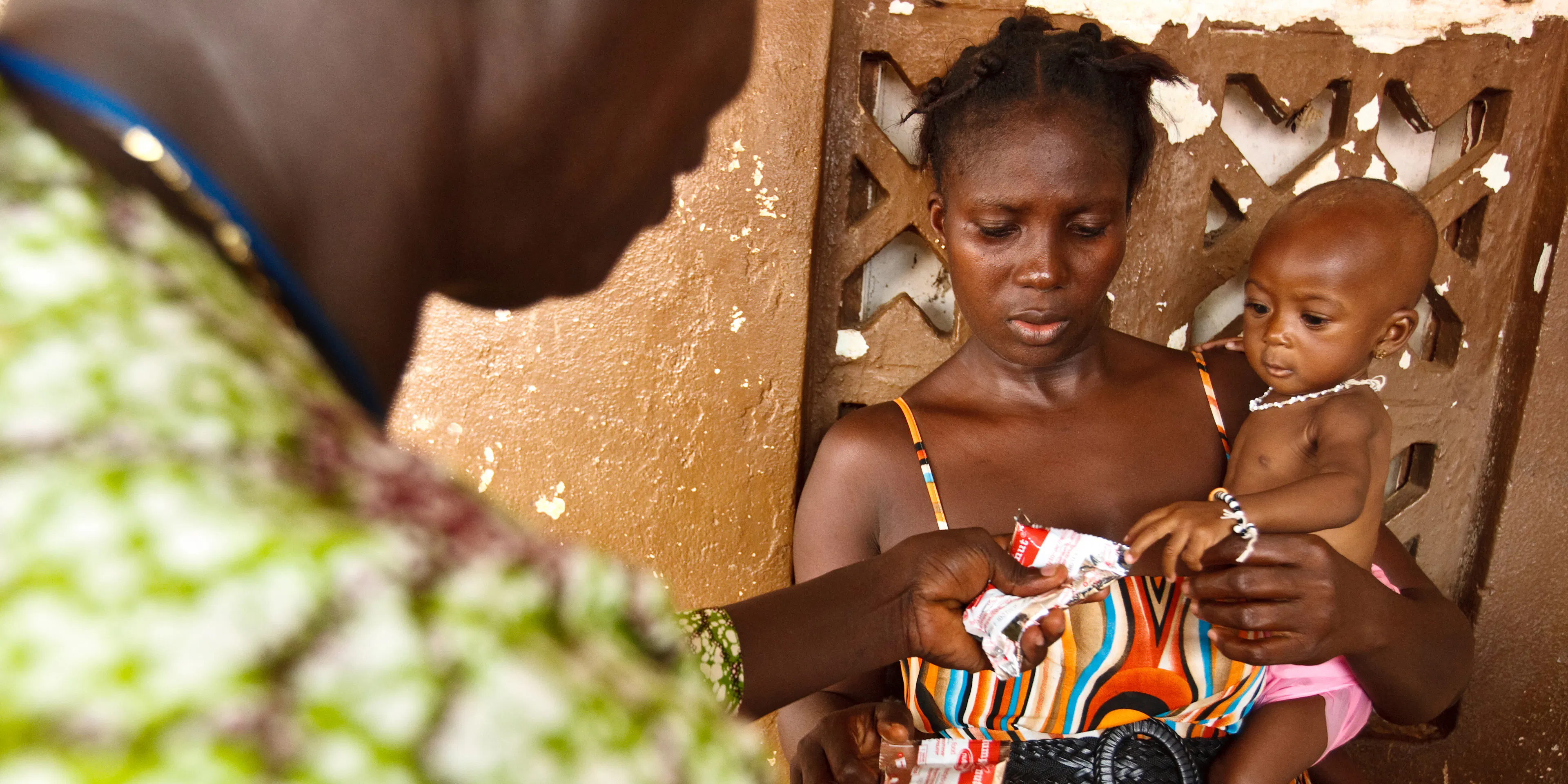 Mother and nurse give baby nutrition 