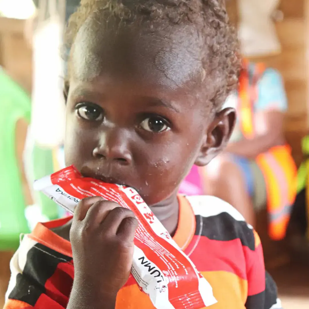 Three-year-old Douglas feeds on life-saving therapeutic food distributed as part of UNICEF-supported nutrition interventions in Western Province.