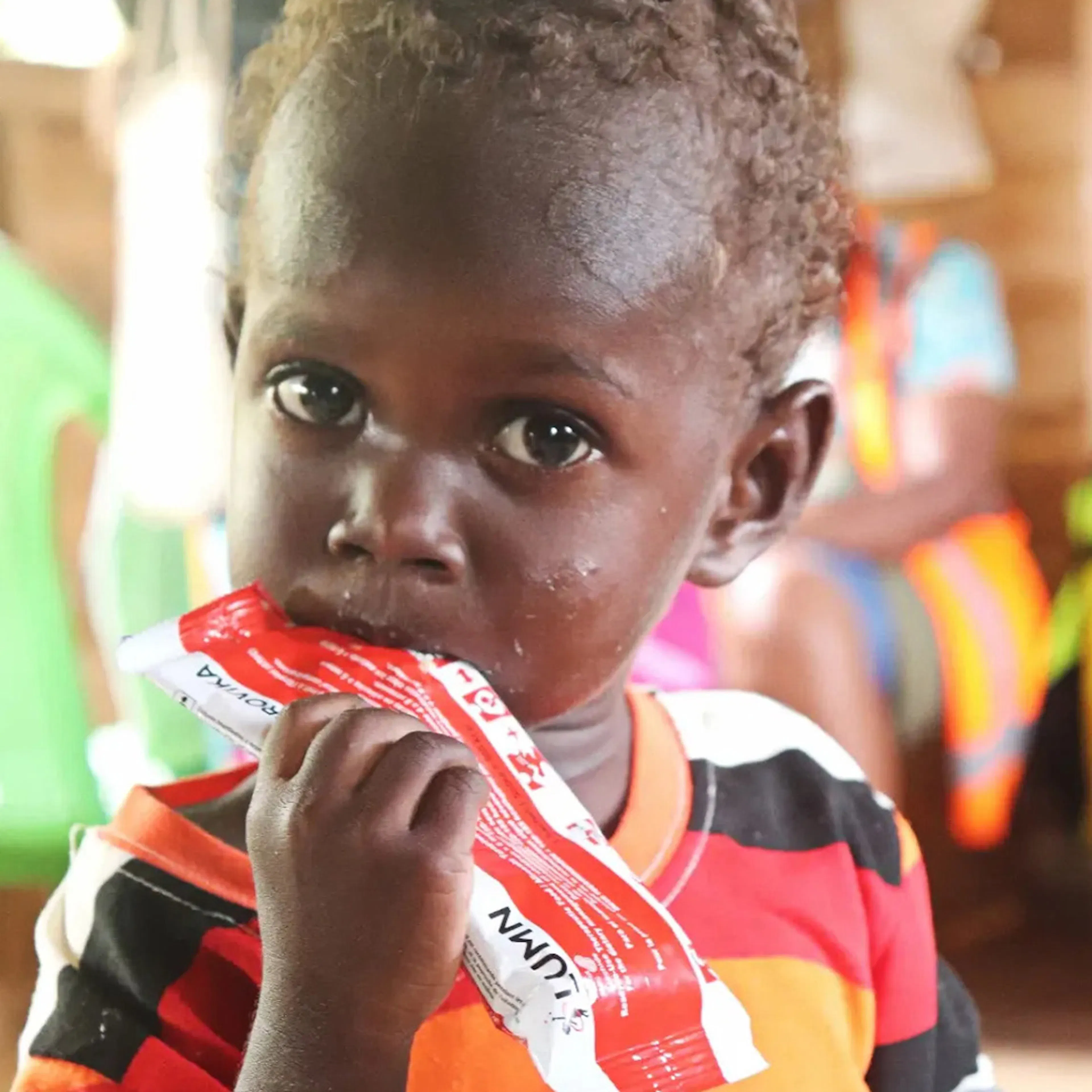 Three-year-old Douglas feeds on life-saving therapeutic food distributed as part of UNICEF-supported nutrition interventions in Western Province. 