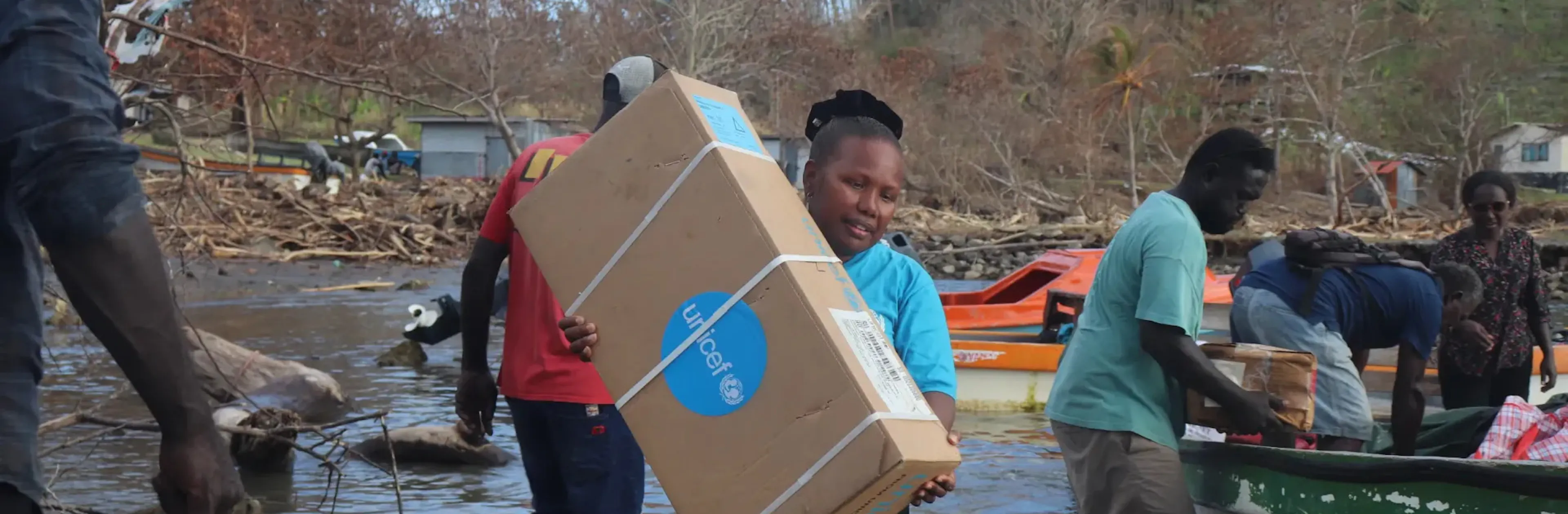 A UNICEF Pacific staff member carries emergency supplies