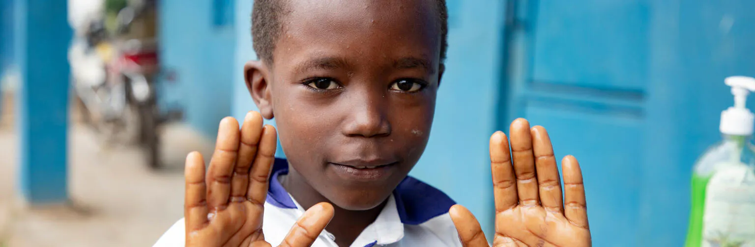 Bahati, 10, shows his hands after washing them at the UNICEF-supported Biringi Primary School in Ituri Province, DR Congo, on 16 May 2026.