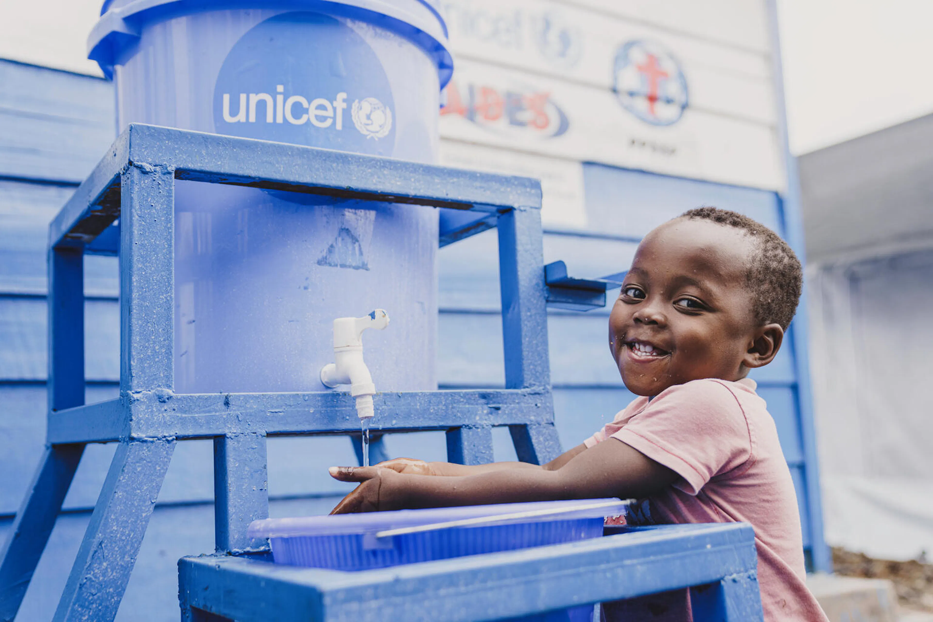 Fabien, 3, washes his hands before his meal at the UNICEF-supported mpox treatment center in Bisengimana, Goma, North Kivu province in DR Congo on December 3, 2024.