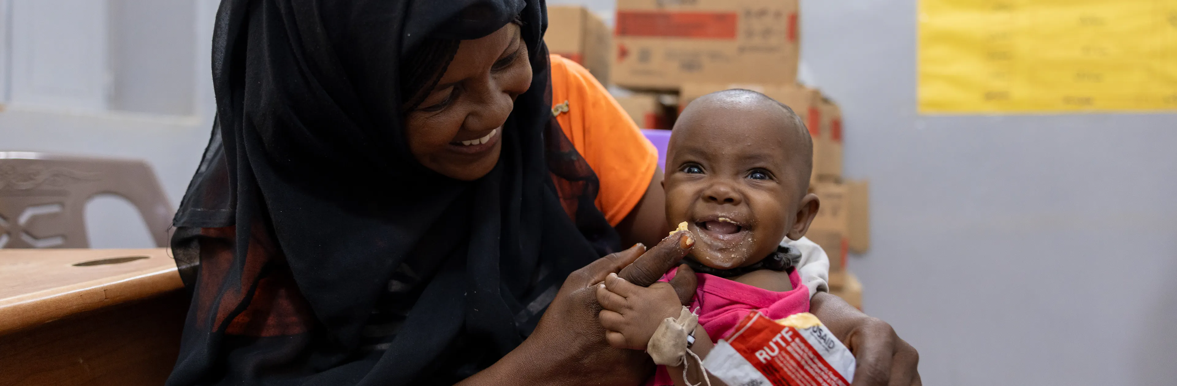 On 27 October, Hadiga feeds her 7 months old daughter Zahara with ready-to-use-therapeutic food (RUTF) at Al Jubarab primary health care facility in Atbara, River Nile State.
