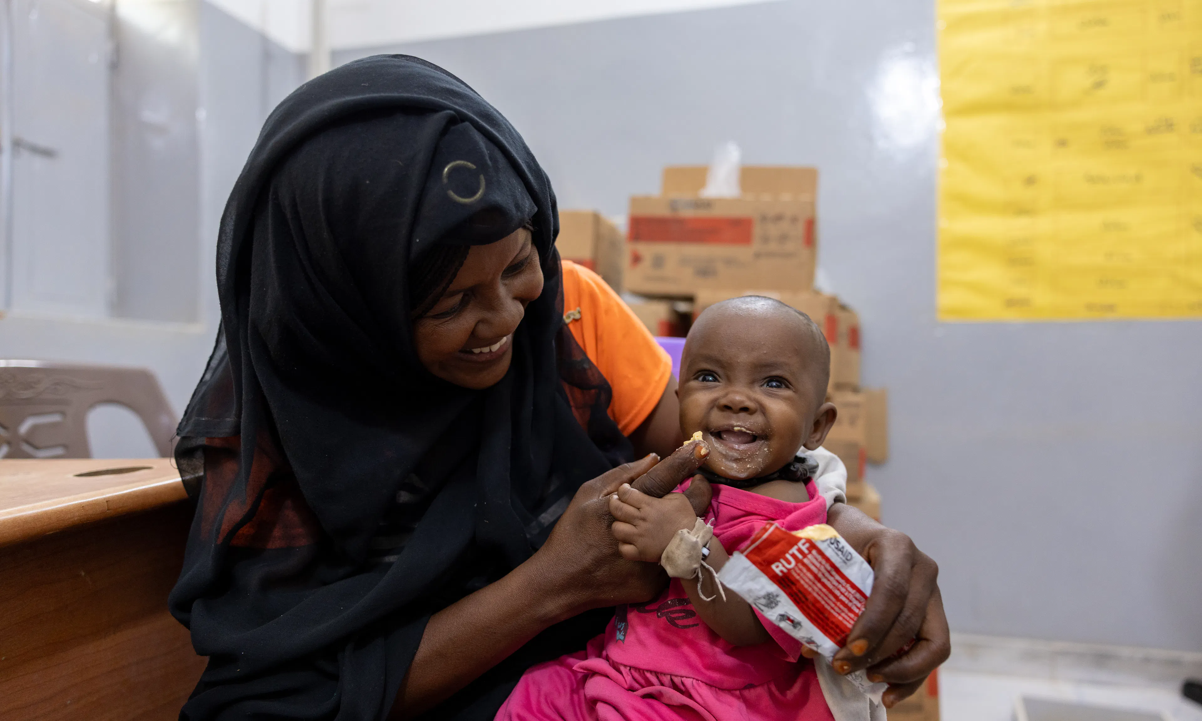 On 27 October, Hadiga feeds her 7 months old daughter Zahara with ready-to-use-therapeutic food (RUTF) at Al Jubarab primary health care facility in Atbara, River Nile State.