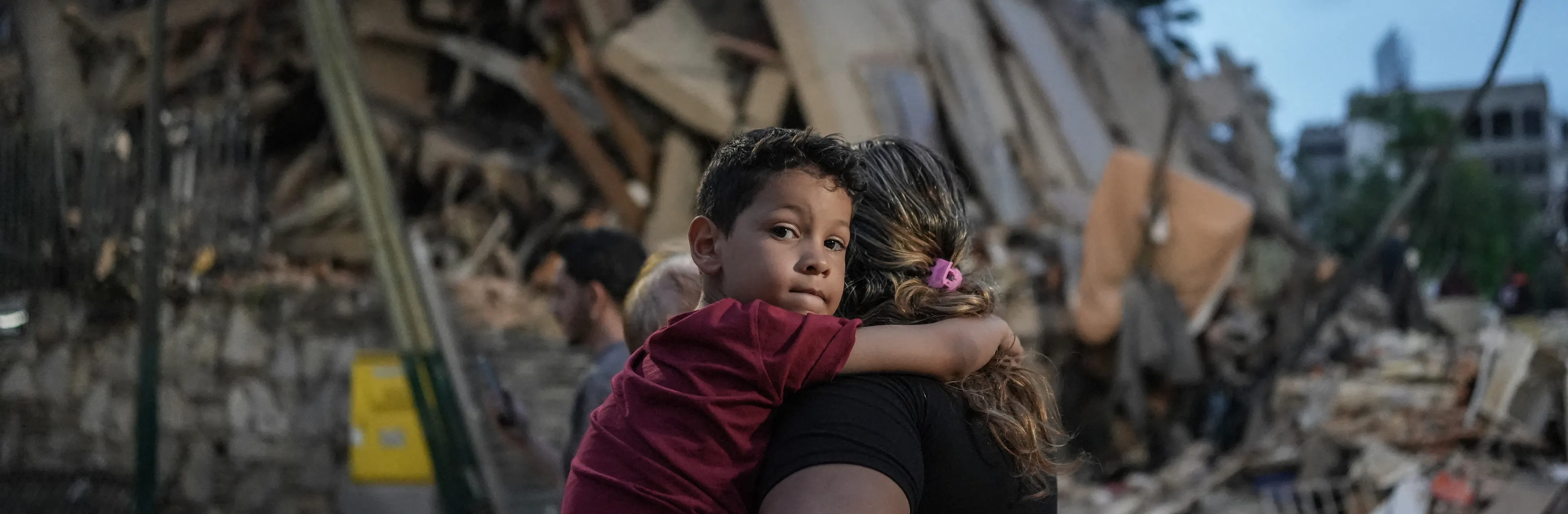 People walk past a collapsed building following an earthquake in Caracas on June 25, 2026.