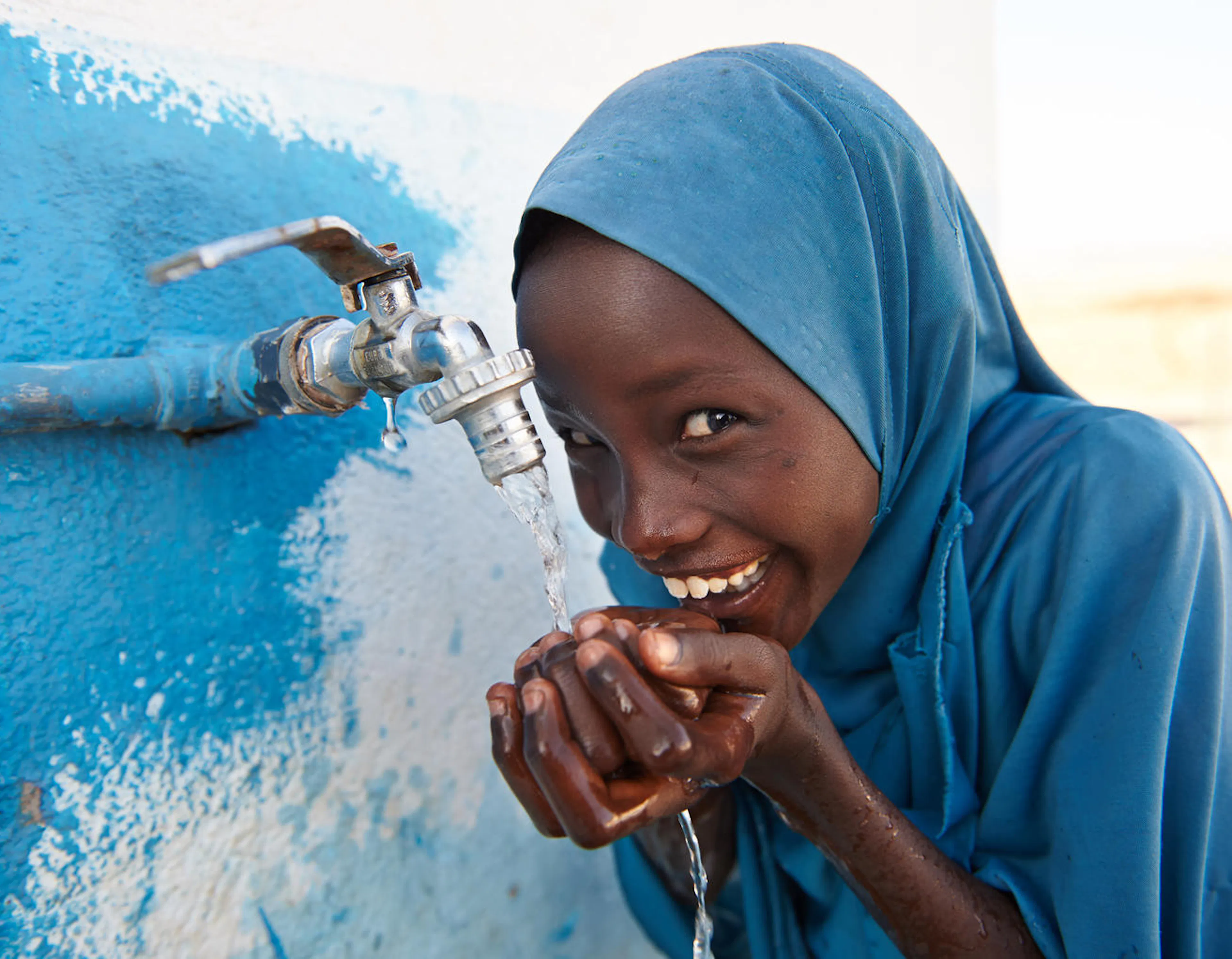 On 6 February 2018, a girl child drinks safe water from a tap outside a UNICEF supported school in the village of Dafo, situated 5 km from the city of Tadjourah, in the southern Djibouti.