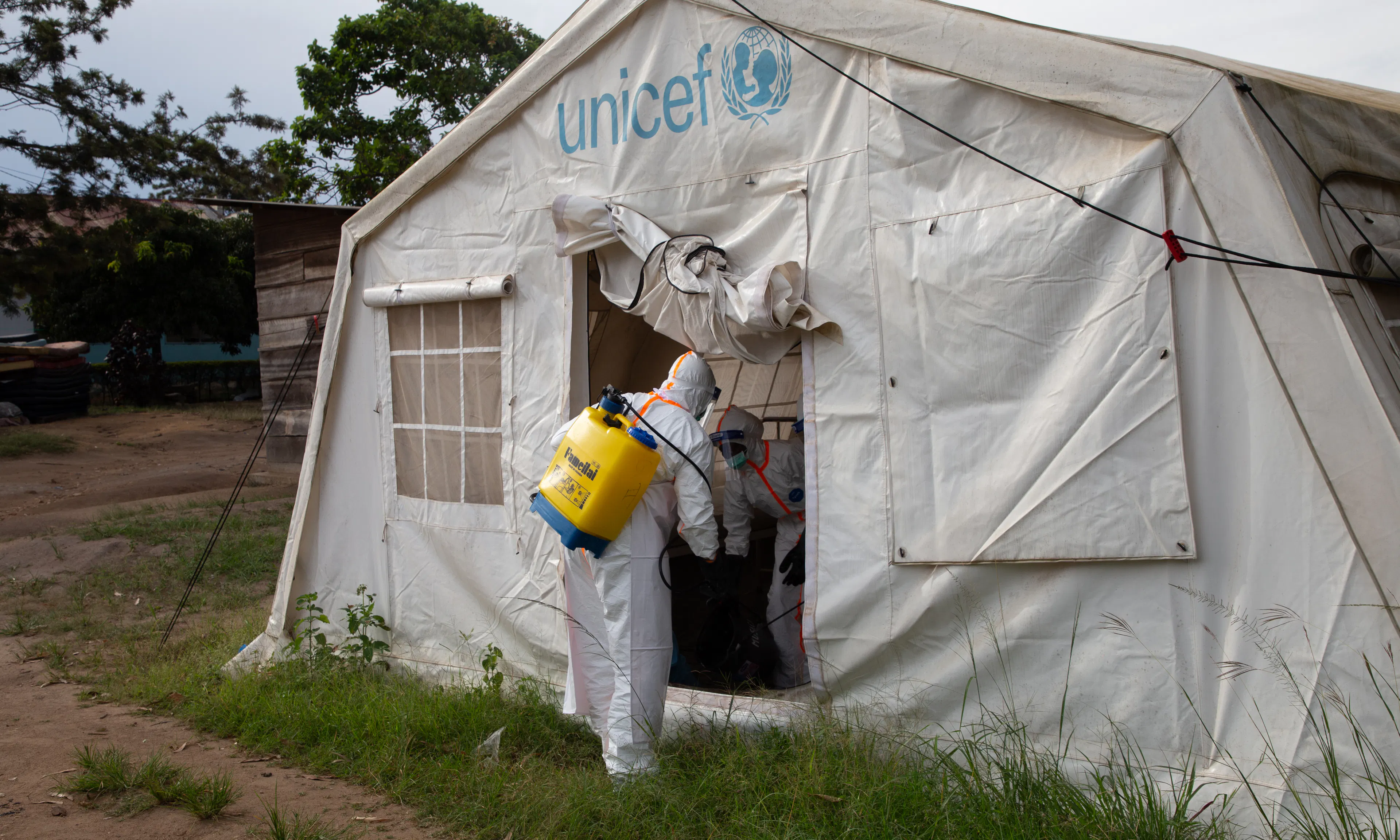 In Bunia, DRC, hygienists supported by UNICEF disinfect a tent.