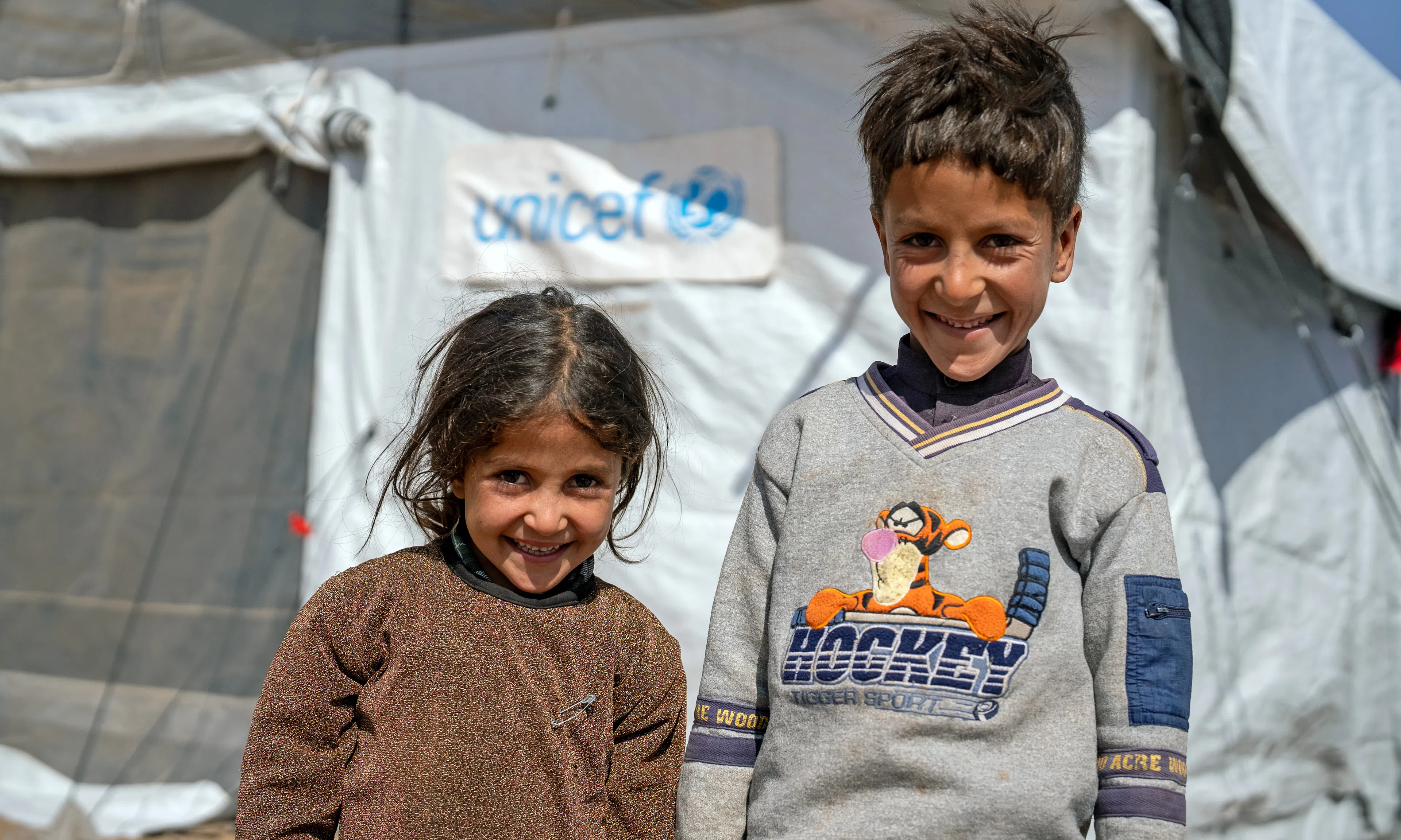 On 14th October 2023, 5 year old Ayshah and her brother, 9 year old Fazel, and survivors of the recent earthquake, stand outside a UNICEF-supported Child Friendly Space in Koshkak village, Zinda Jan District, western Afghanistan.