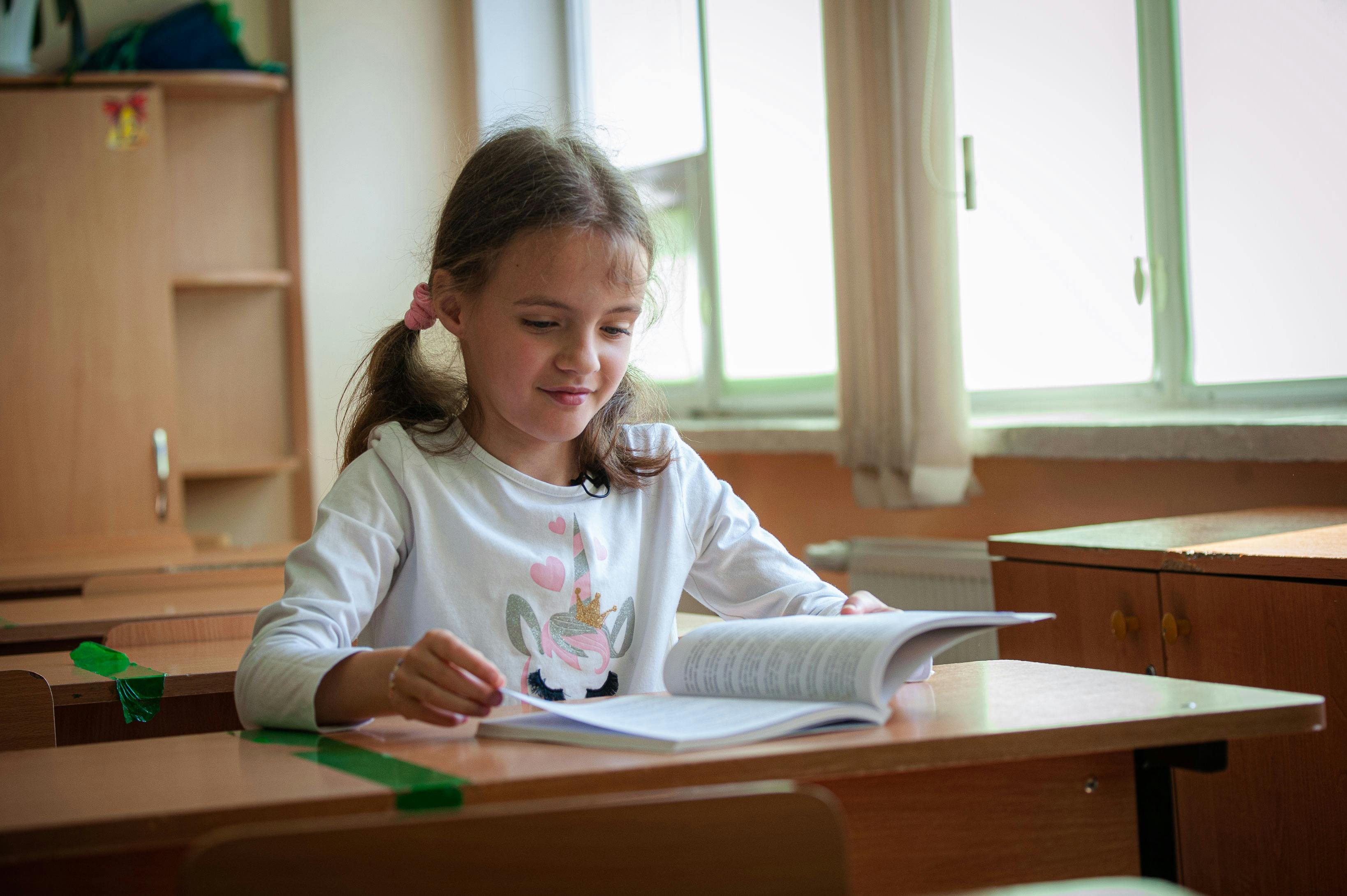 10-year-old Sasha sits at her desk on the last day of the school term at at a central city school in Chisnau, Moldova.