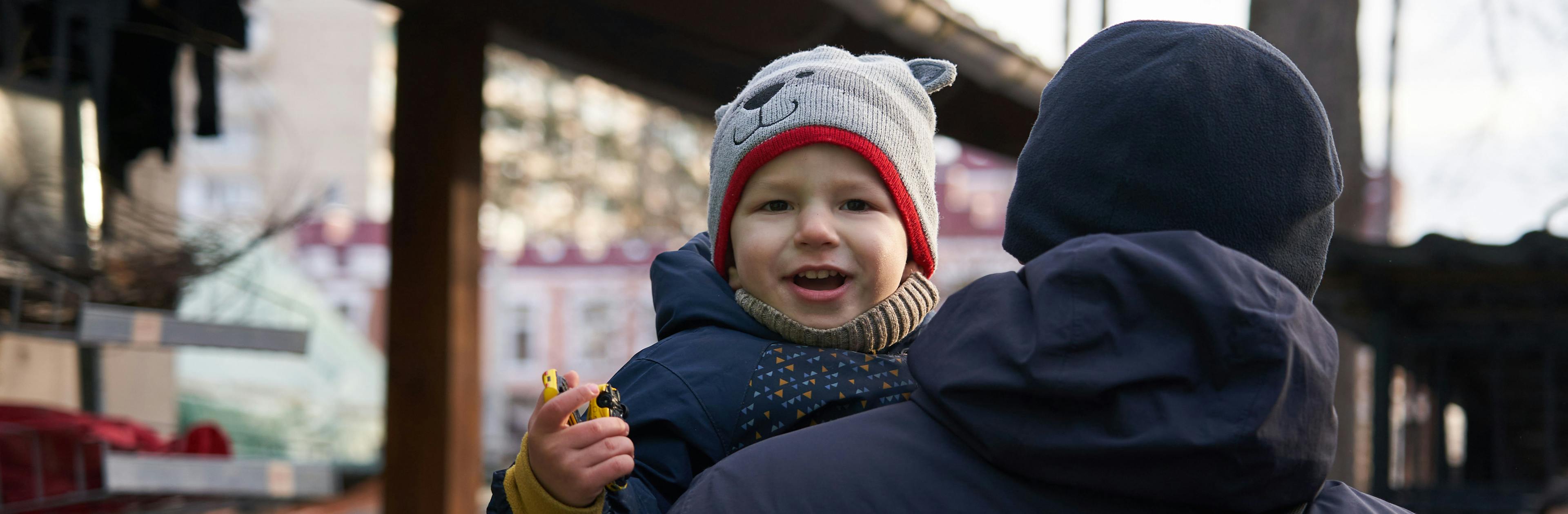 30 December 2022, Irpin, Kyiv oblast, Ukraine. Bohdan (2) in the yard of his house with his father.