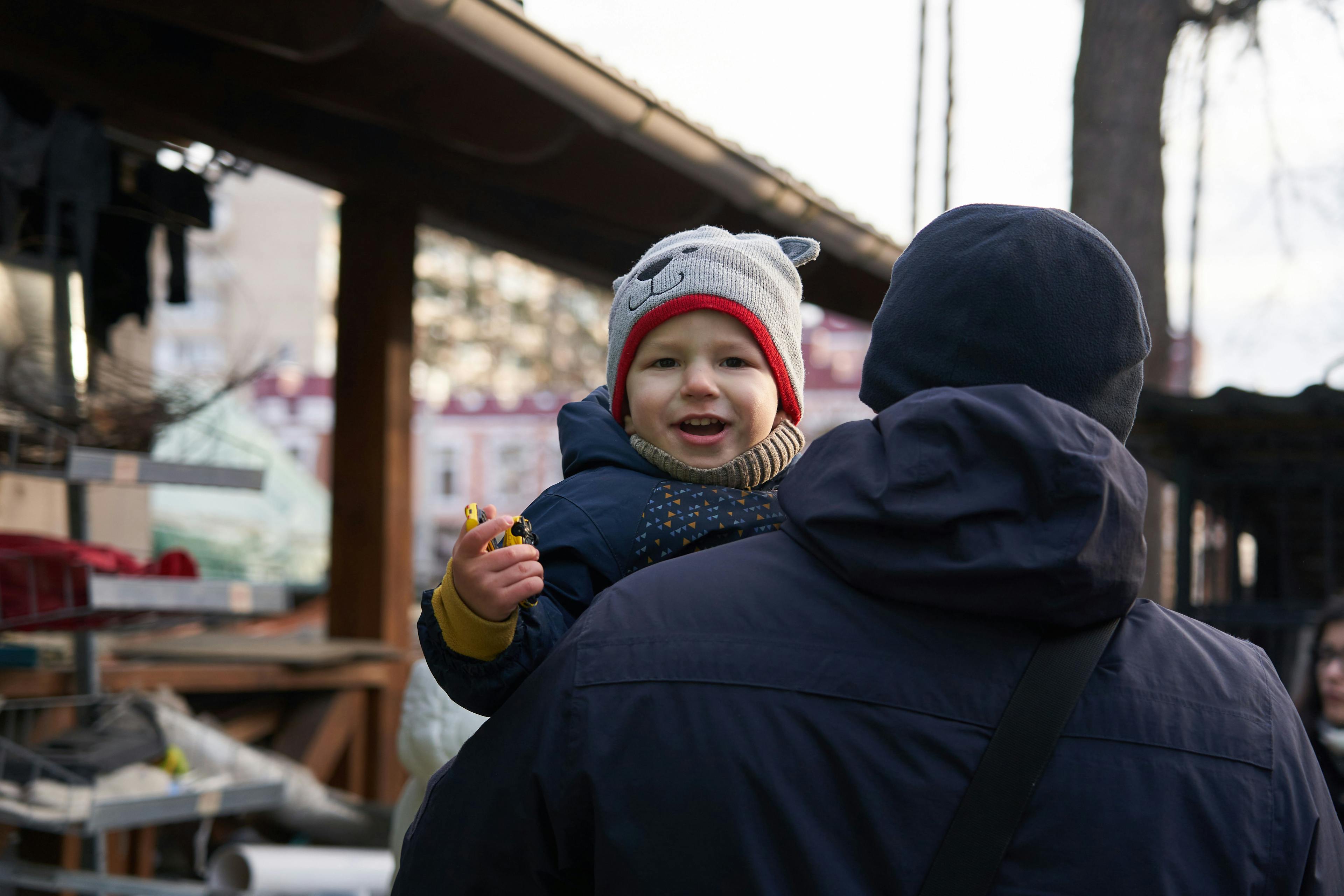 30 December 2022, Irpin, Kyiv oblast, Ukraine. Bohdan (2) in the yard of his house with his father.