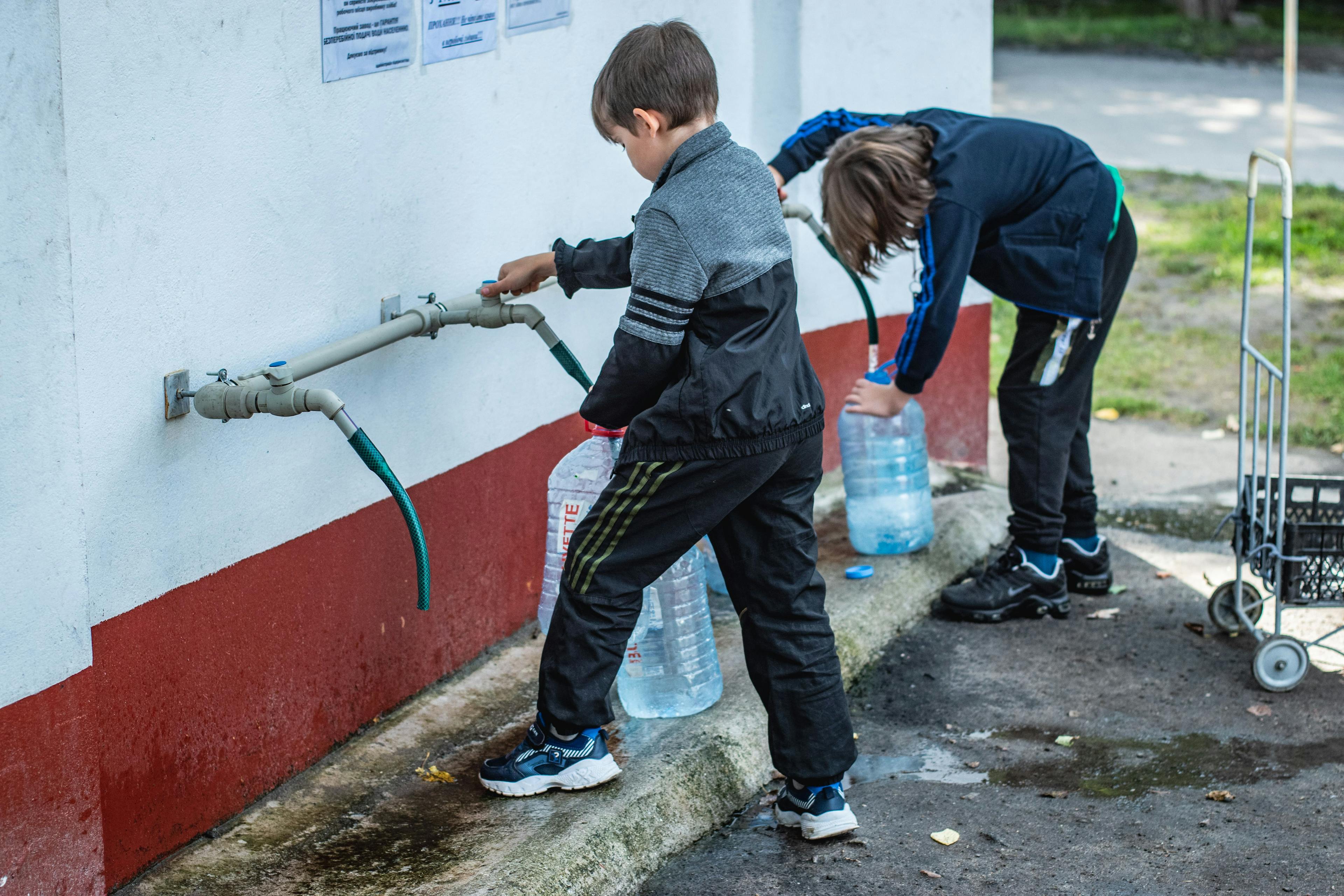Children getting access to drinking water. 