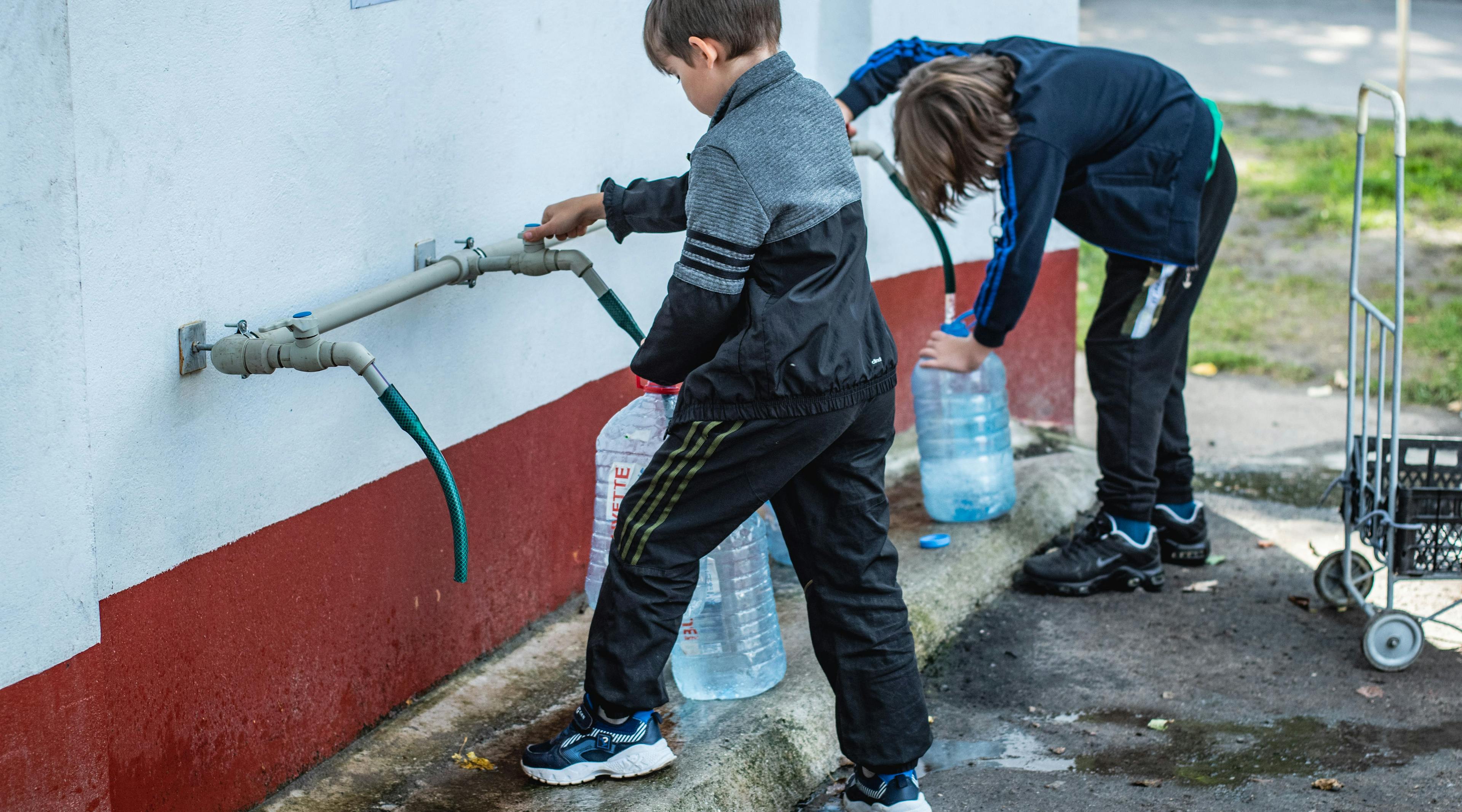 Children getting access to drinking water. 