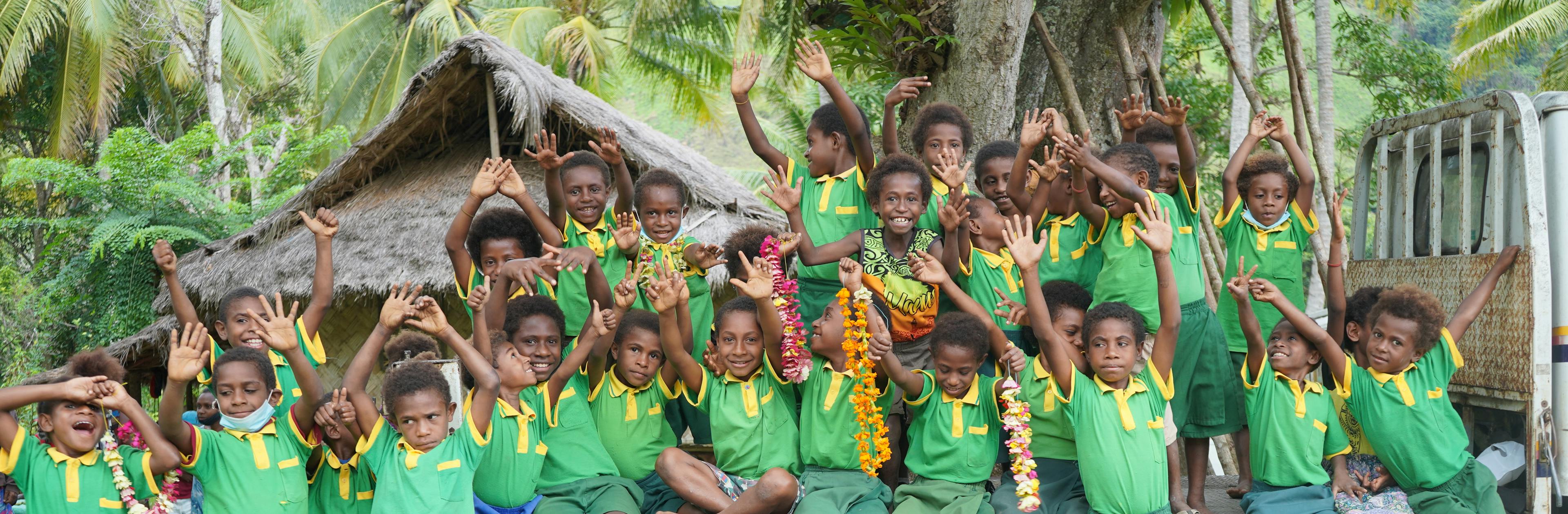 Students from Wagon Early Learning Centre in Kasuka Community, Nawaeb District, Morobe Province wait to receive a UNICEF, World Vision and ADRA team going to visit WASH interventions in their community