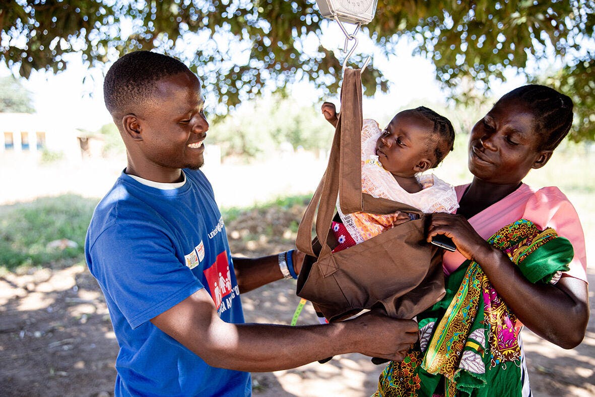 A family attend the GMP (Growth Monitoring Clinic) at the Feni Health Facility in Zambia where babies are weighed and MUAC is taken to screen for malnutrition