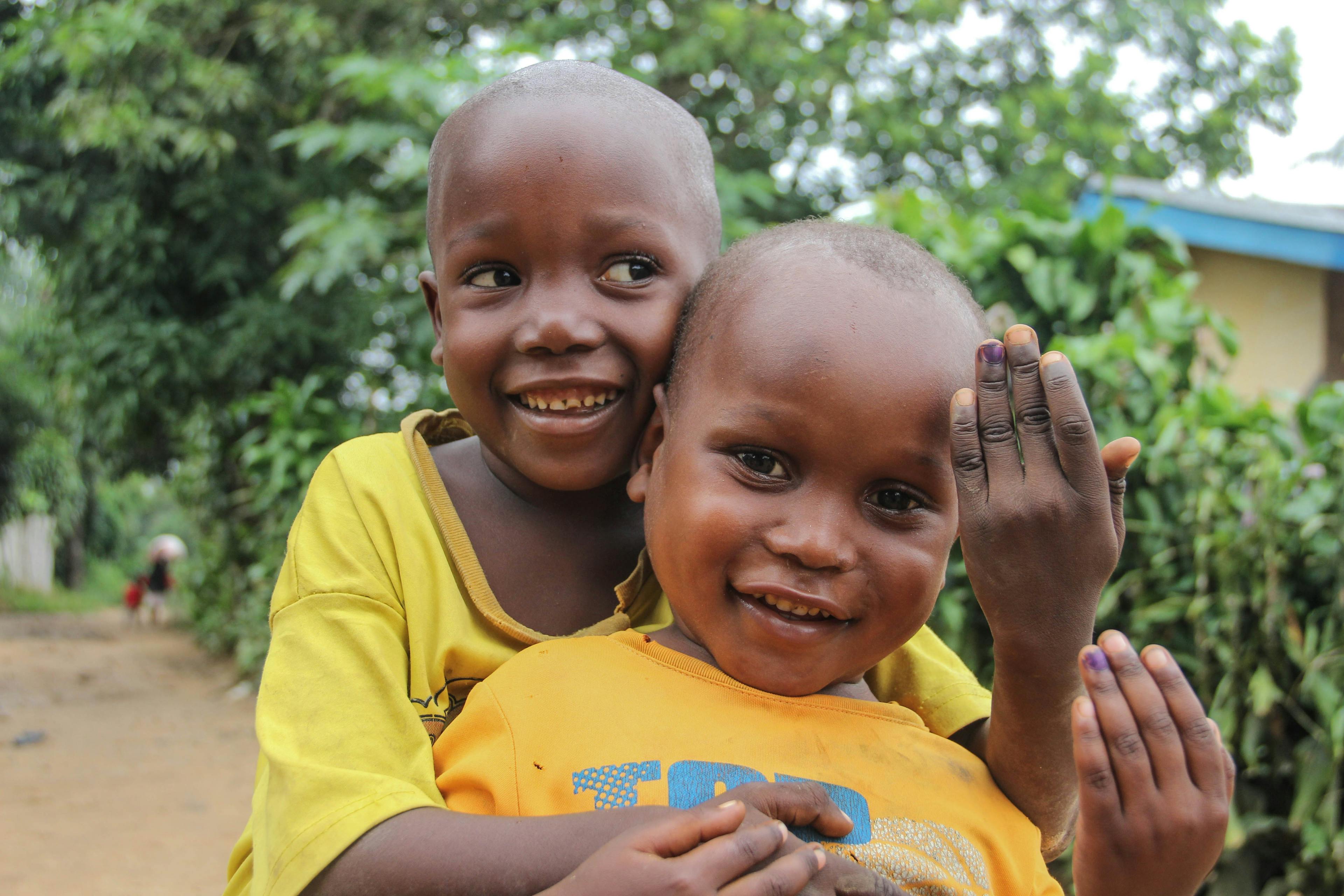 Immunisation - Michael and David show off their purple marked fingers that show they've received their polio vaccination