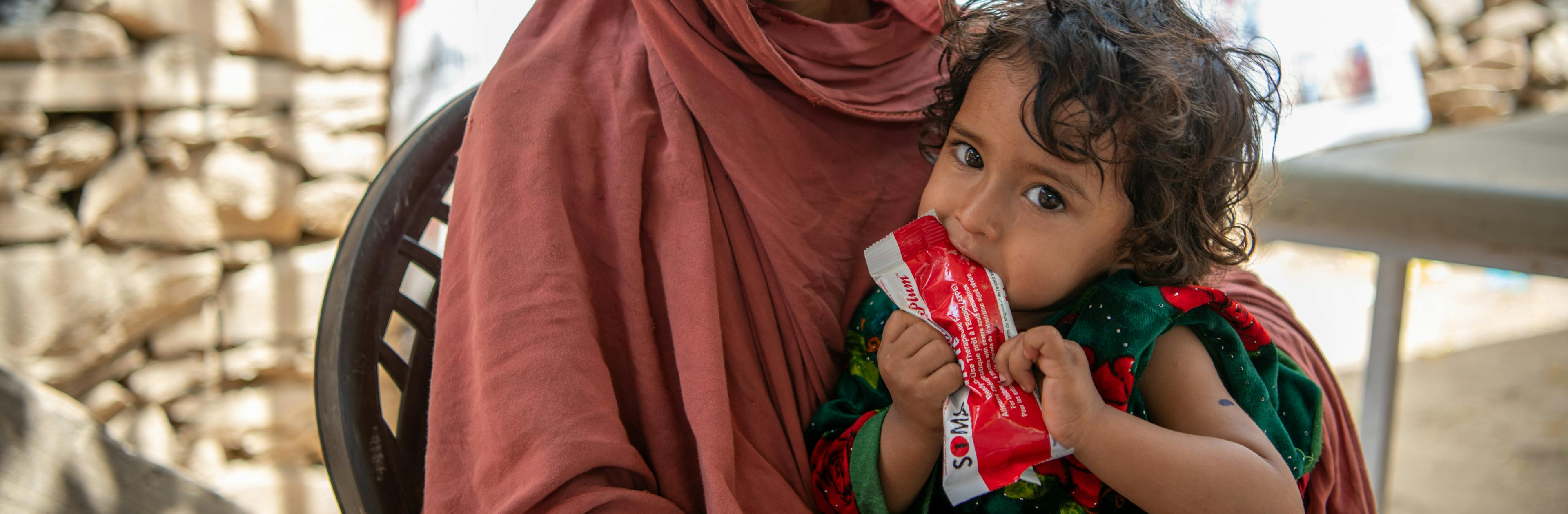 On June 25 2023, a child named Zarmina receives RUTF at UNICEF-supported mobile health and nutrition teams (MHNTs) in Samsagal village, Nari District, Kunar, Afghanistan.