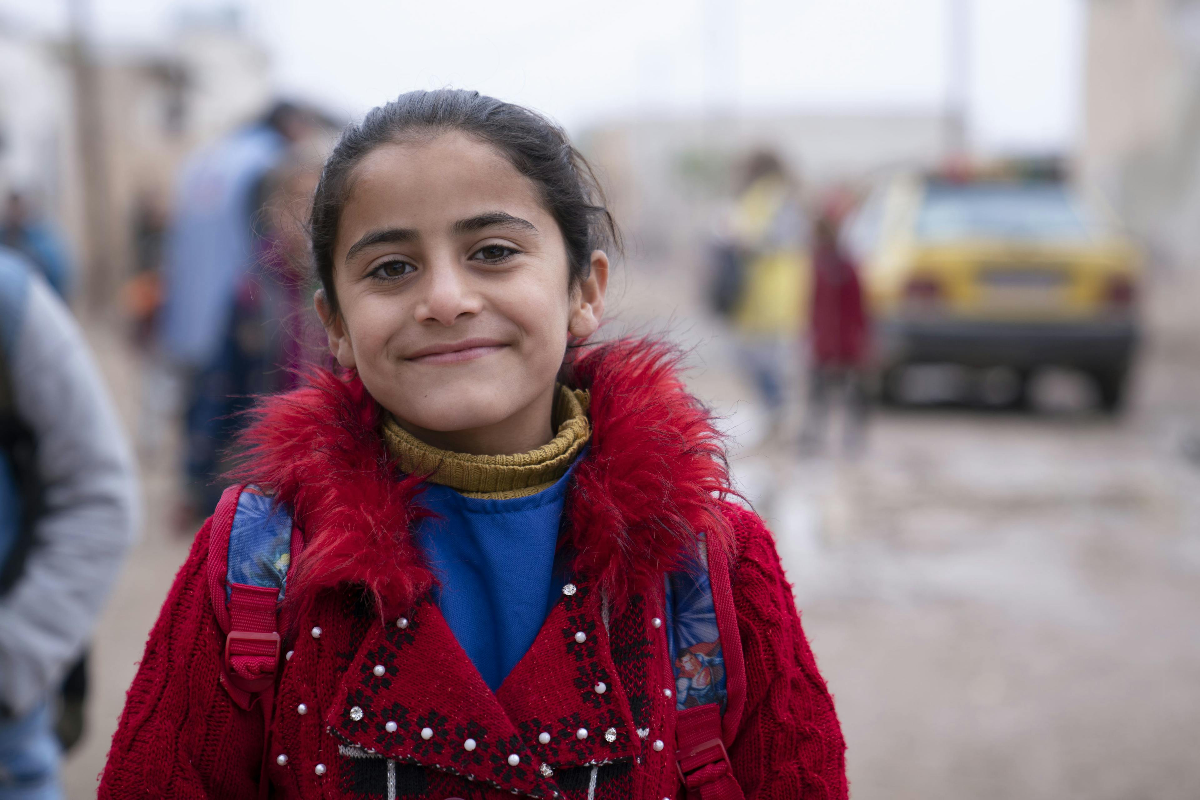 Sara smiling after receiving her oral cholera vaccination. She was one of many children who attended the vaccination campaign held by a UNICEF-supported mobile team.