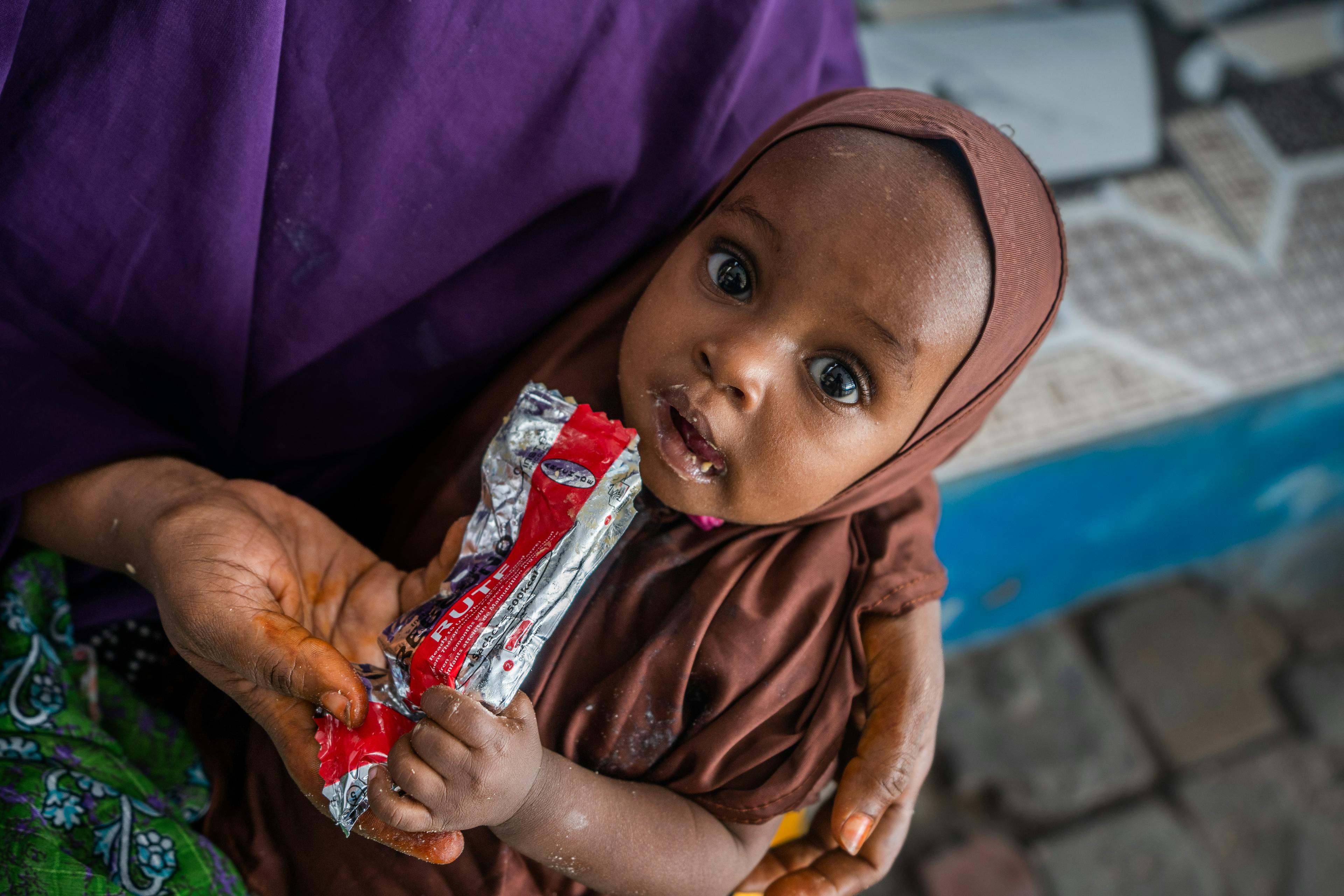 Catching signs of malnutrition early - a child receives RUTF treatment