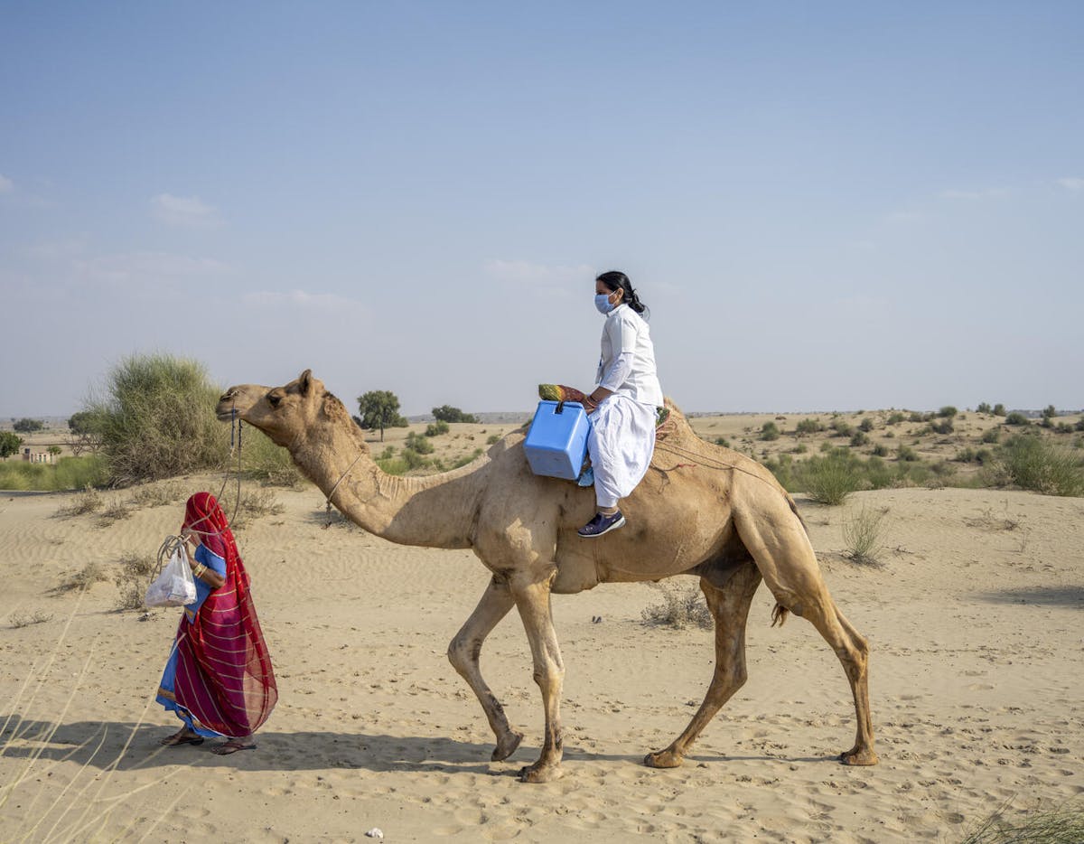 Immunisation - Riding camel-back through deserts to reach remote villages in India.