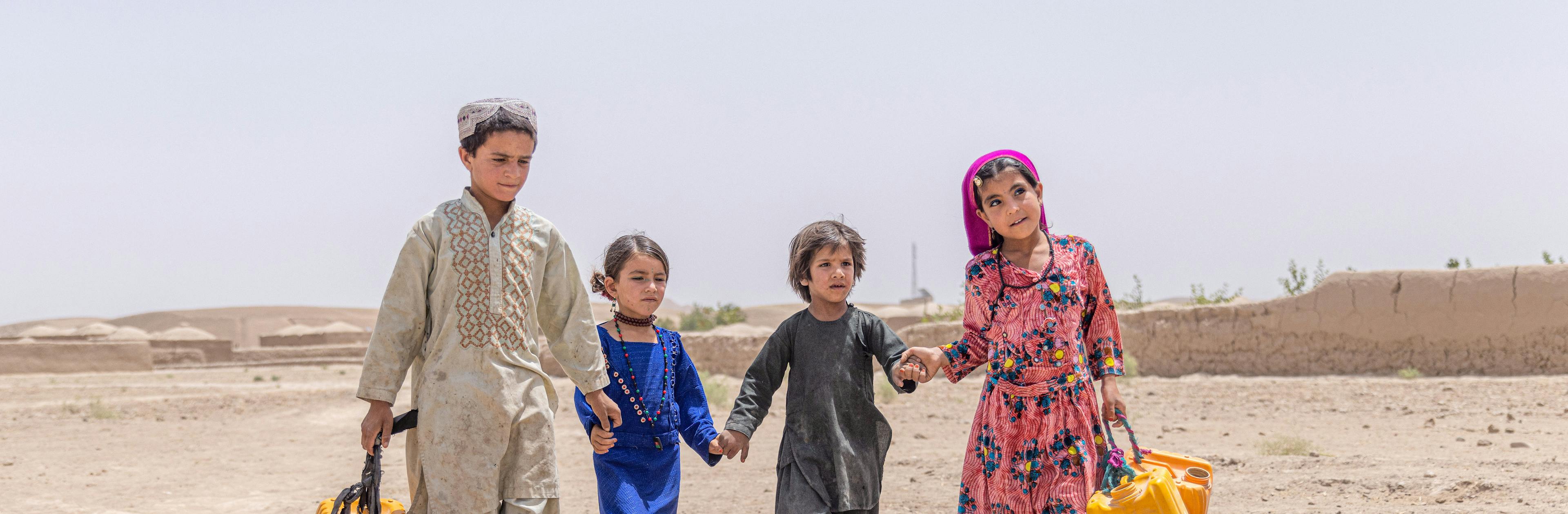 On 25 July 2023, children walk with their jerry cans to collect water from a UNICEF supported tap, located in the heart of their village in Badghis Province, Afghanistan.