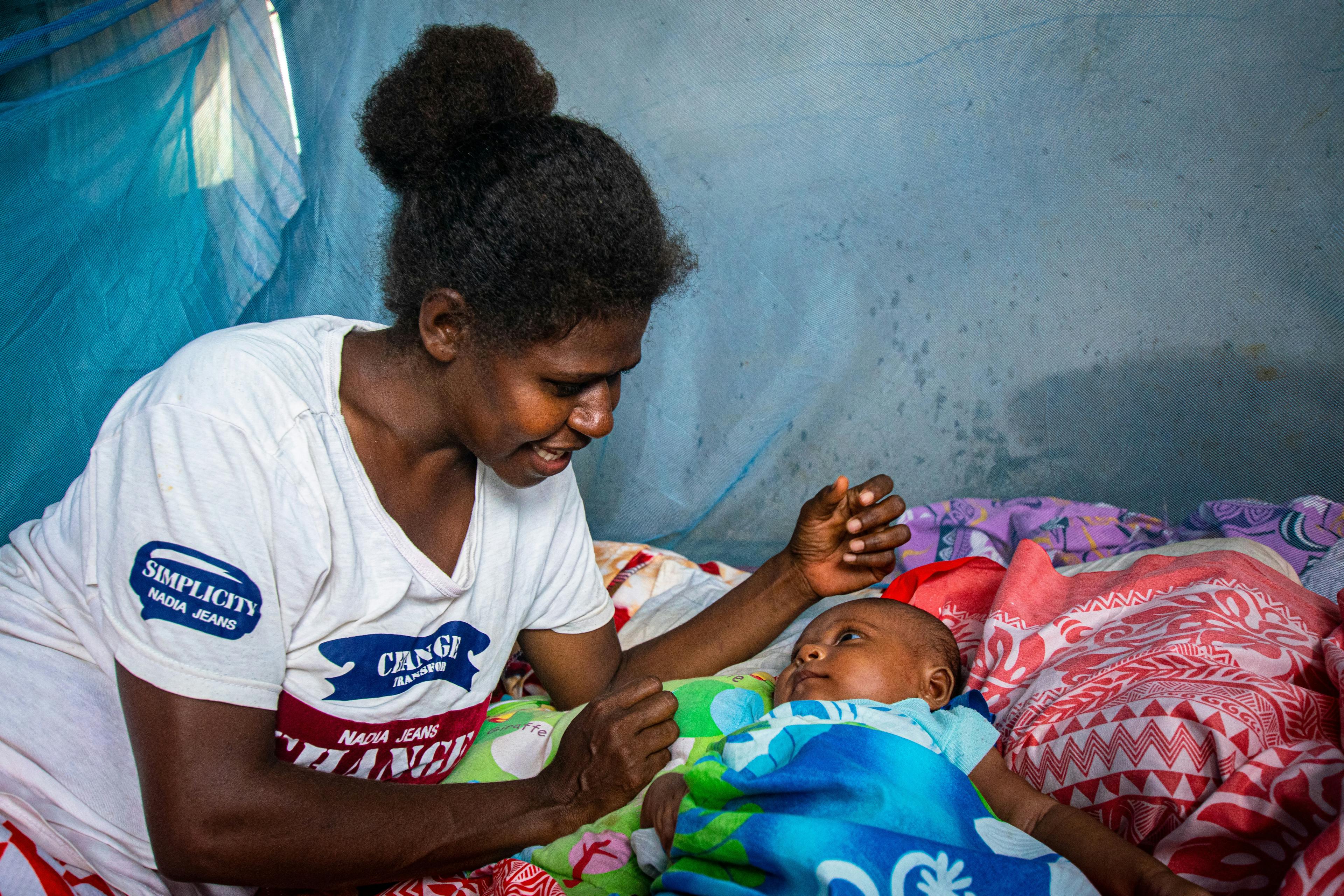 Cecil smiles at her baby Lydia after they survived a cyclone in Vanuatu