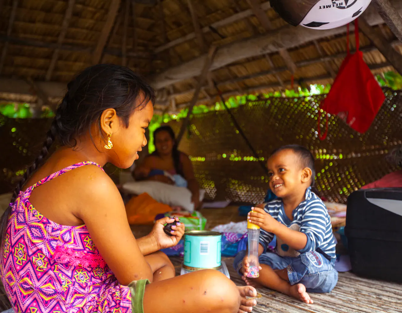 Health & Medicine- Naibobou, four-years-old and Taumwaon, eight-years-old who play energetically together in their open air ‘maneaba’ home.